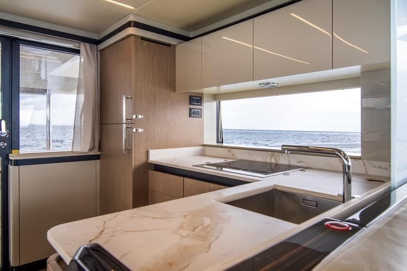 Luxurious kitchen interior of 2023 Absolute 62 Fly yacht with ocean view.