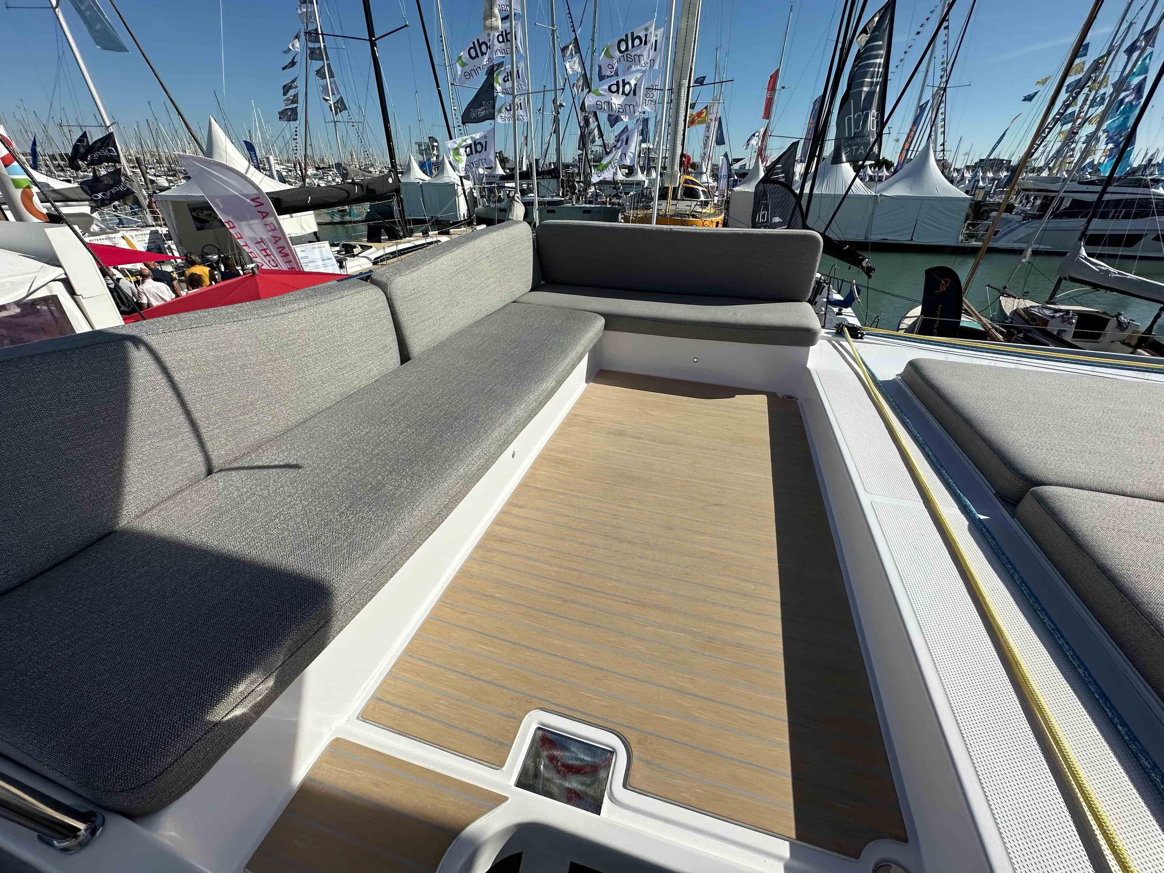 Spacious deck seating on 2025 NEEL 52 Hybrid at a boat show.
