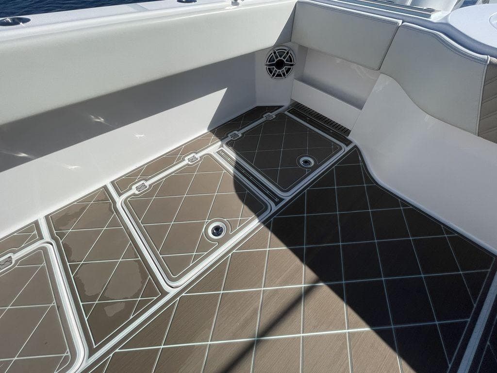 2019 Invincible 40 Catamaran deck with storage compartments and non-slip flooring.