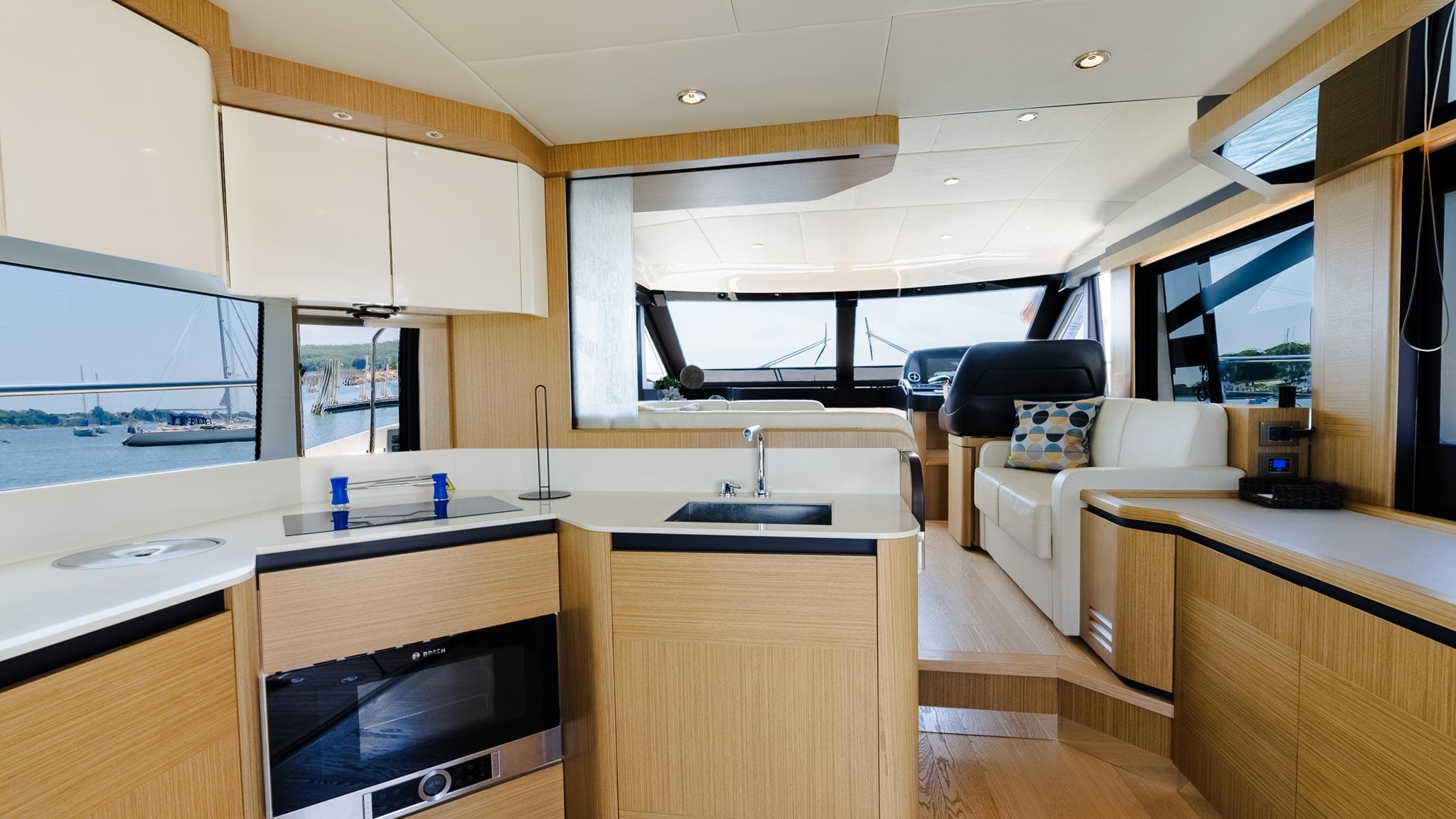 Luxurious interior of 2017 Absolute 50 Fly yacht with modern kitchen and seating area.