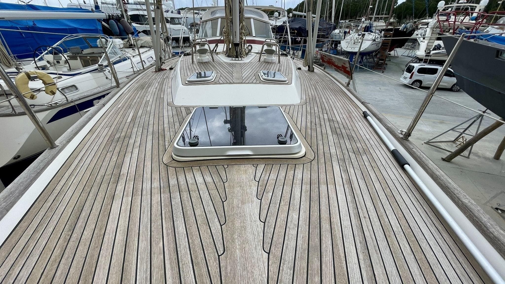 Teak deck of 2001 Najad 460 yacht in marina setting.