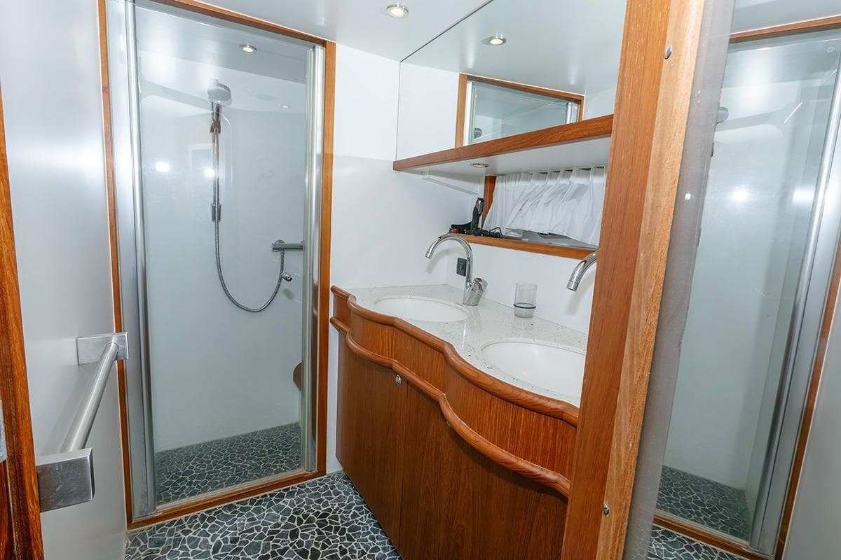 Luxurious bathroom in 2009 Altena 53 Custom Trawler with dual sinks and modern shower.