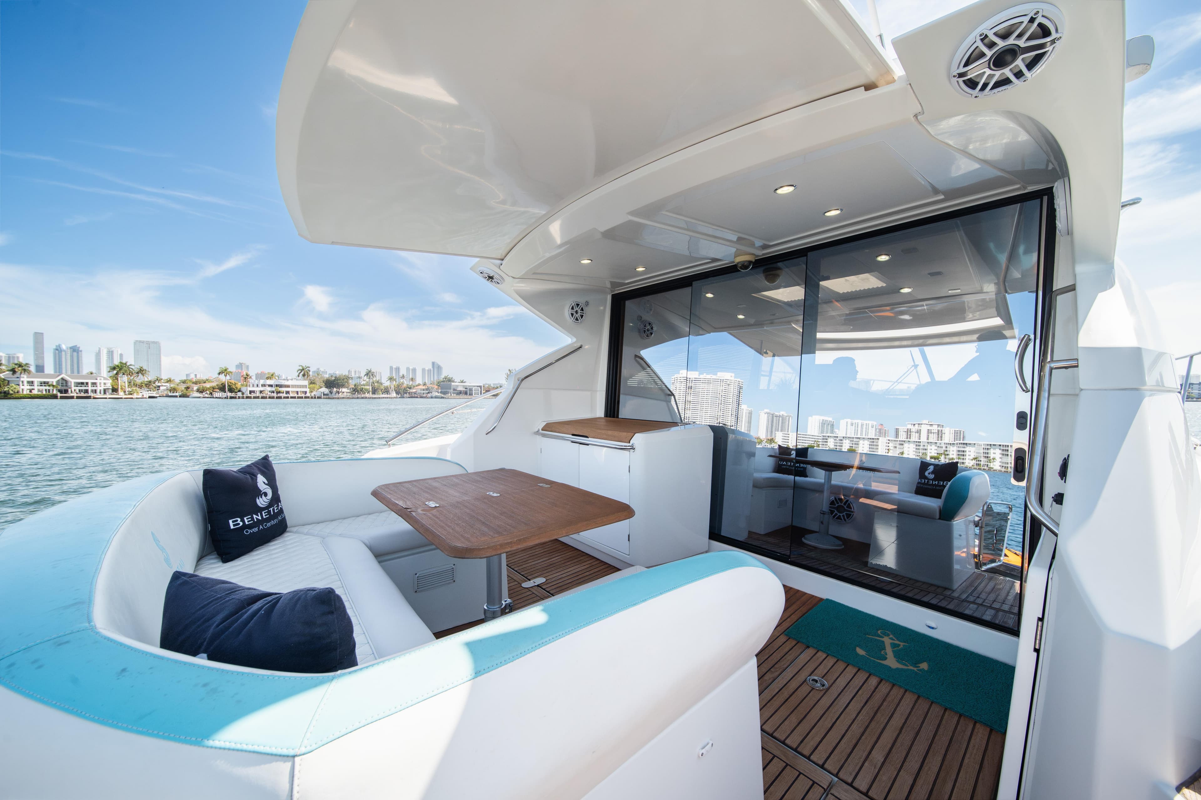 Luxurious 2010 Beneteau Monte Carlo 47 yacht with elegant seating and scenic waterfront views.