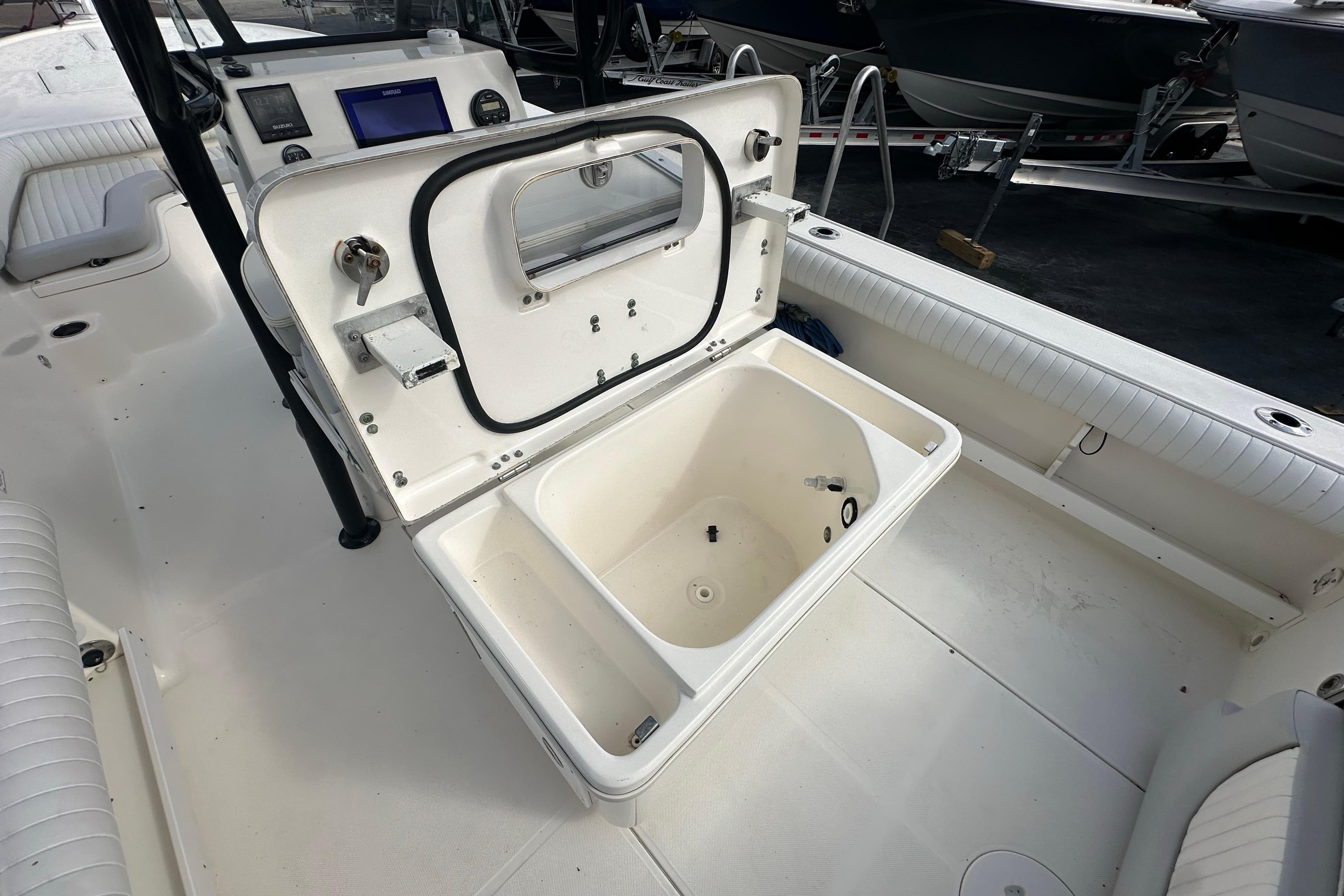 2018 Sea Born FX25 Bay boat interior with open storage compartment.