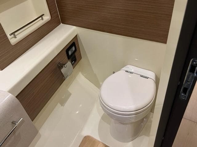 2018 Chris-Craft Launch 38 boat bathroom with modern fixtures and wood accents.
