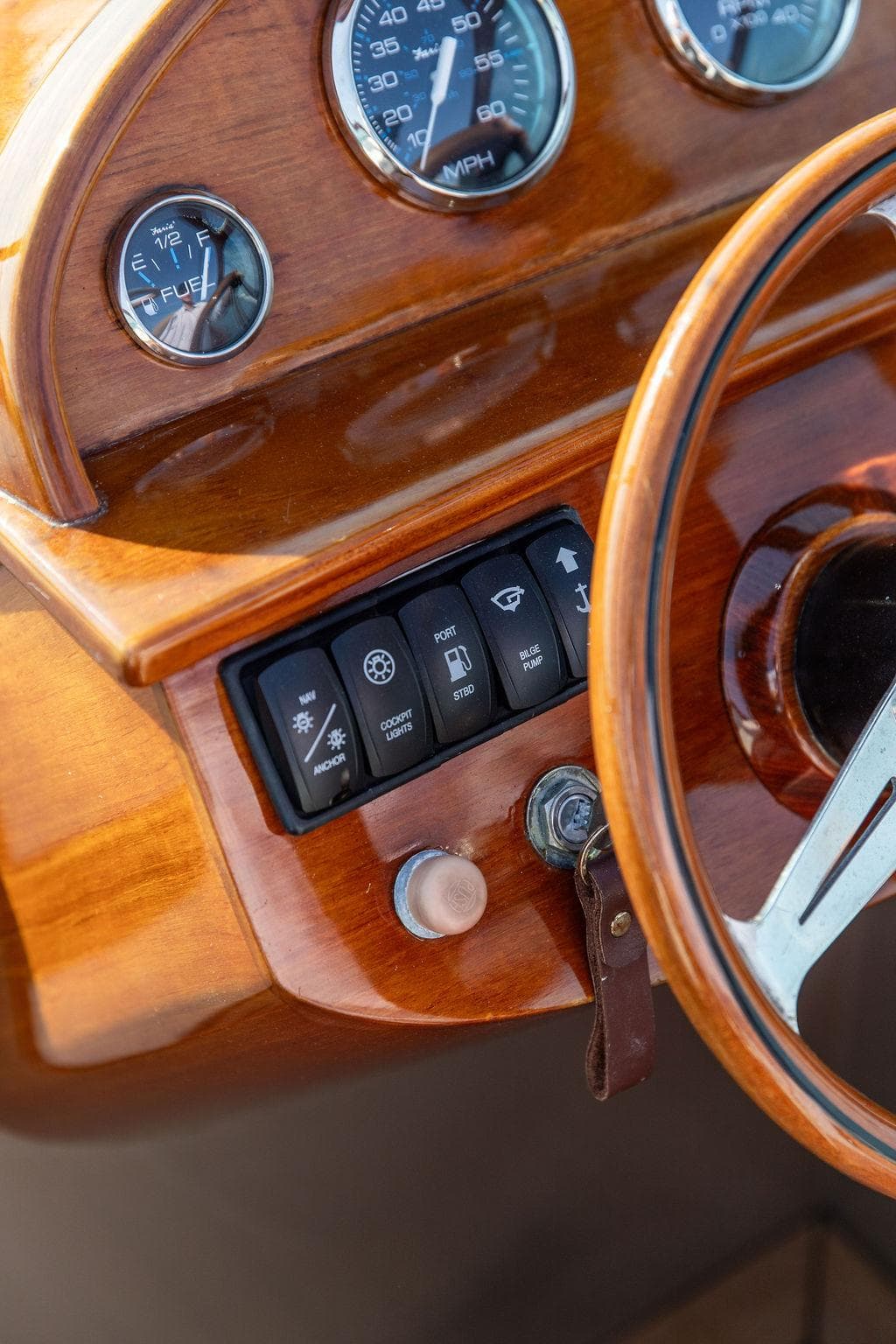 2003 Hinckley Talaria 29R dashboard with wooden finish and control switches.