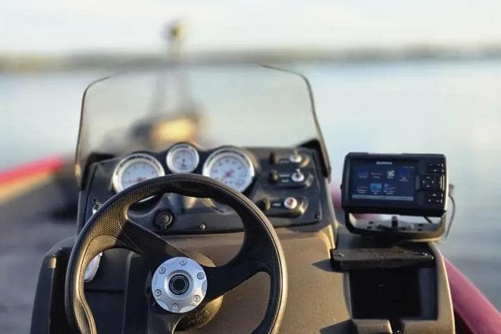 2021 Tracker Super Guide V-16 SC boat dashboard with steering wheel and navigation system.