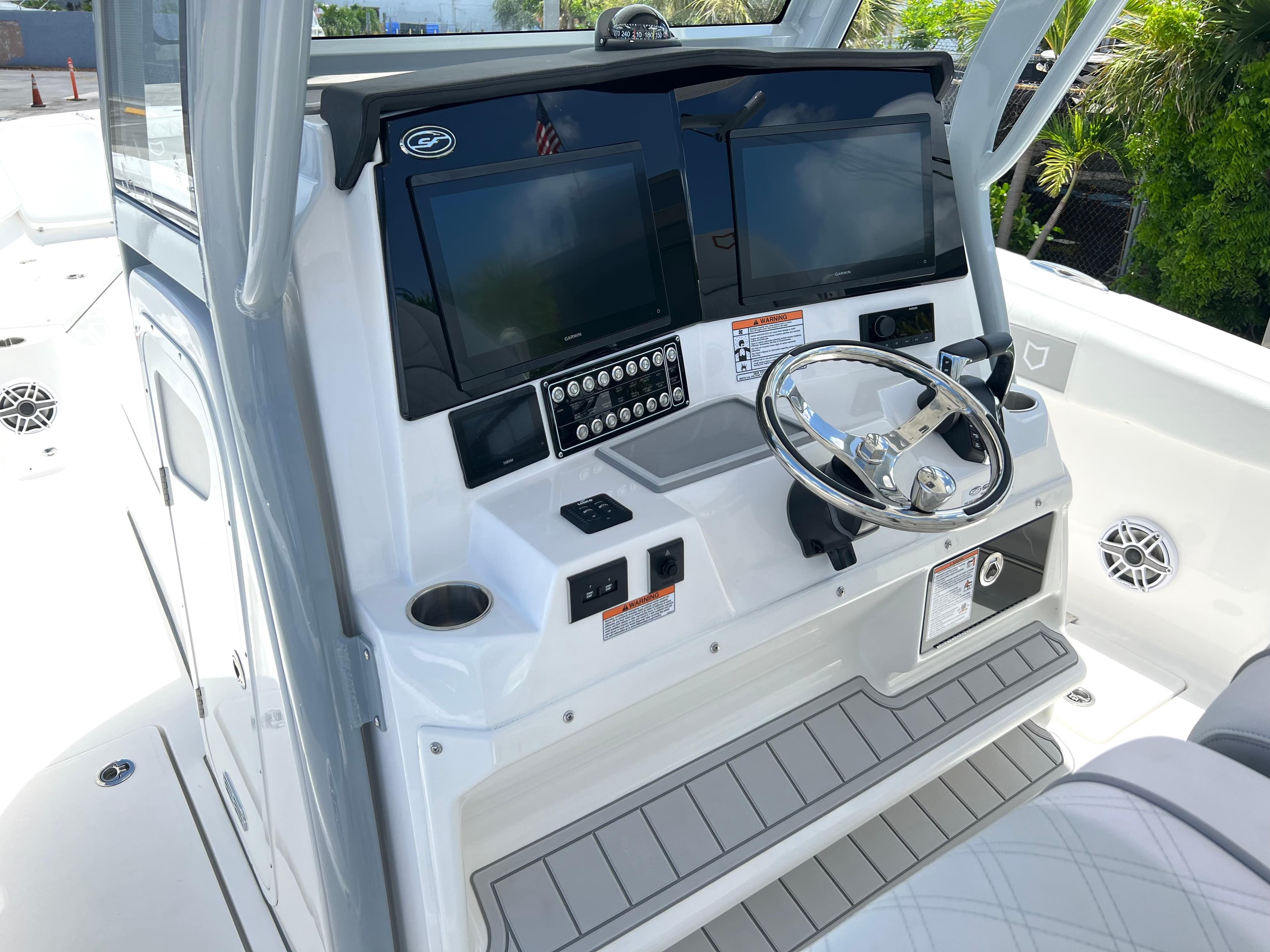 2025 Sea Fox 328 Commander boat helm with dual screens and steering wheel.