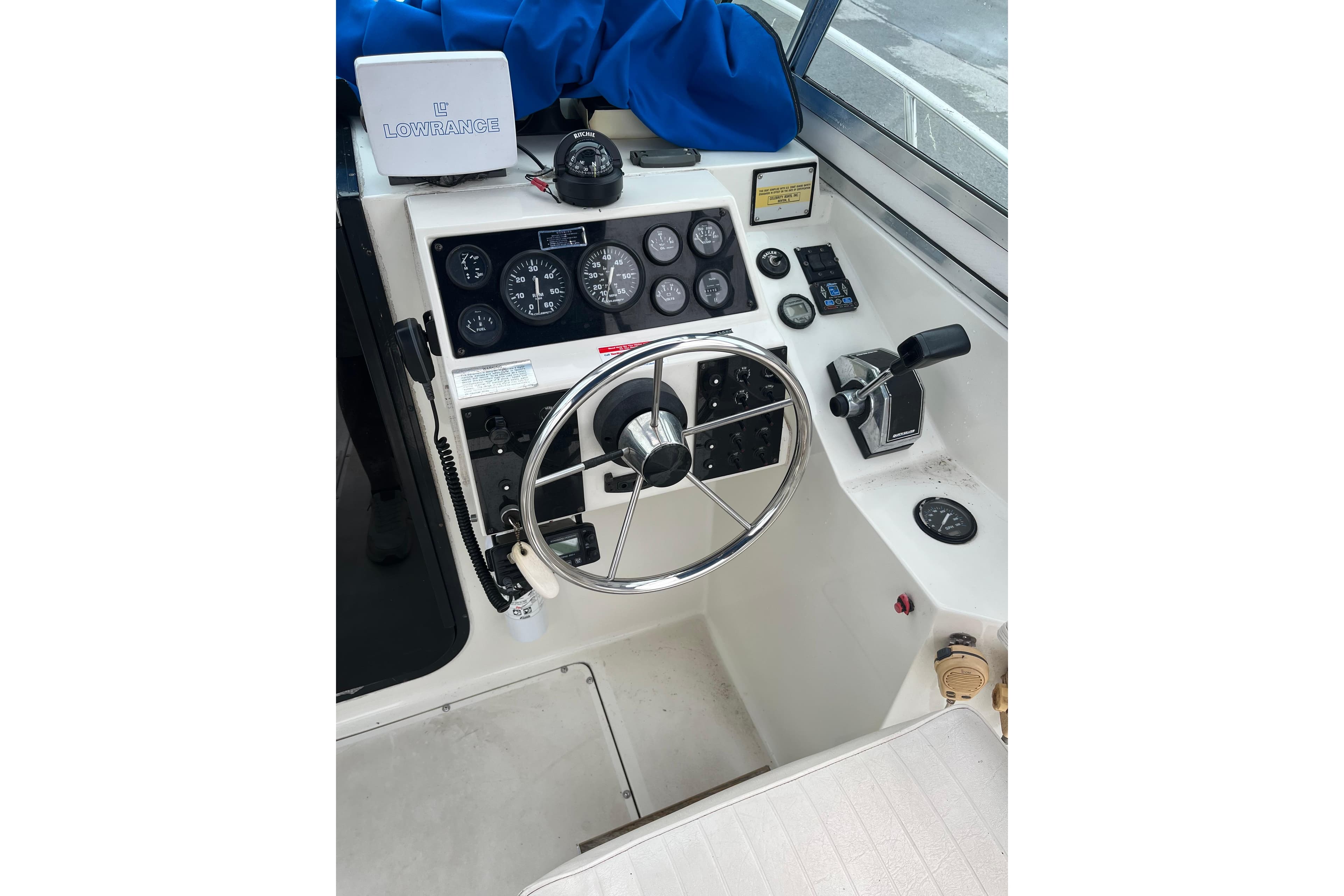 1995 Celebrity 2500 Fish Hawk boat dashboard with steering wheel and control panel.