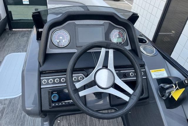 2026 Godfrey Monaco 235 SFLC boat dashboard with steering wheel and control panel.
