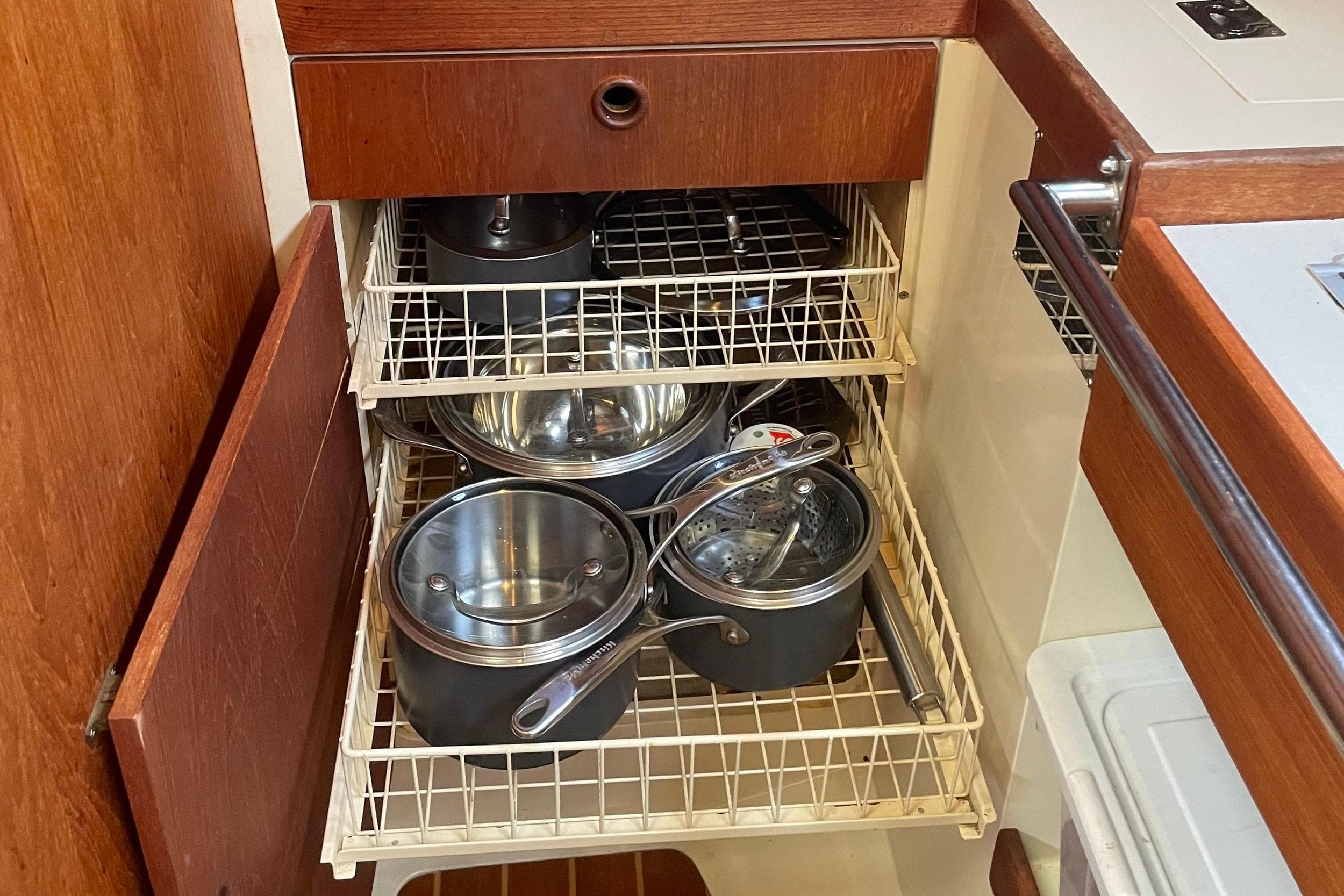 Kitchen storage with pots and pans in a 1988 CS 36 Merlin sailboat.