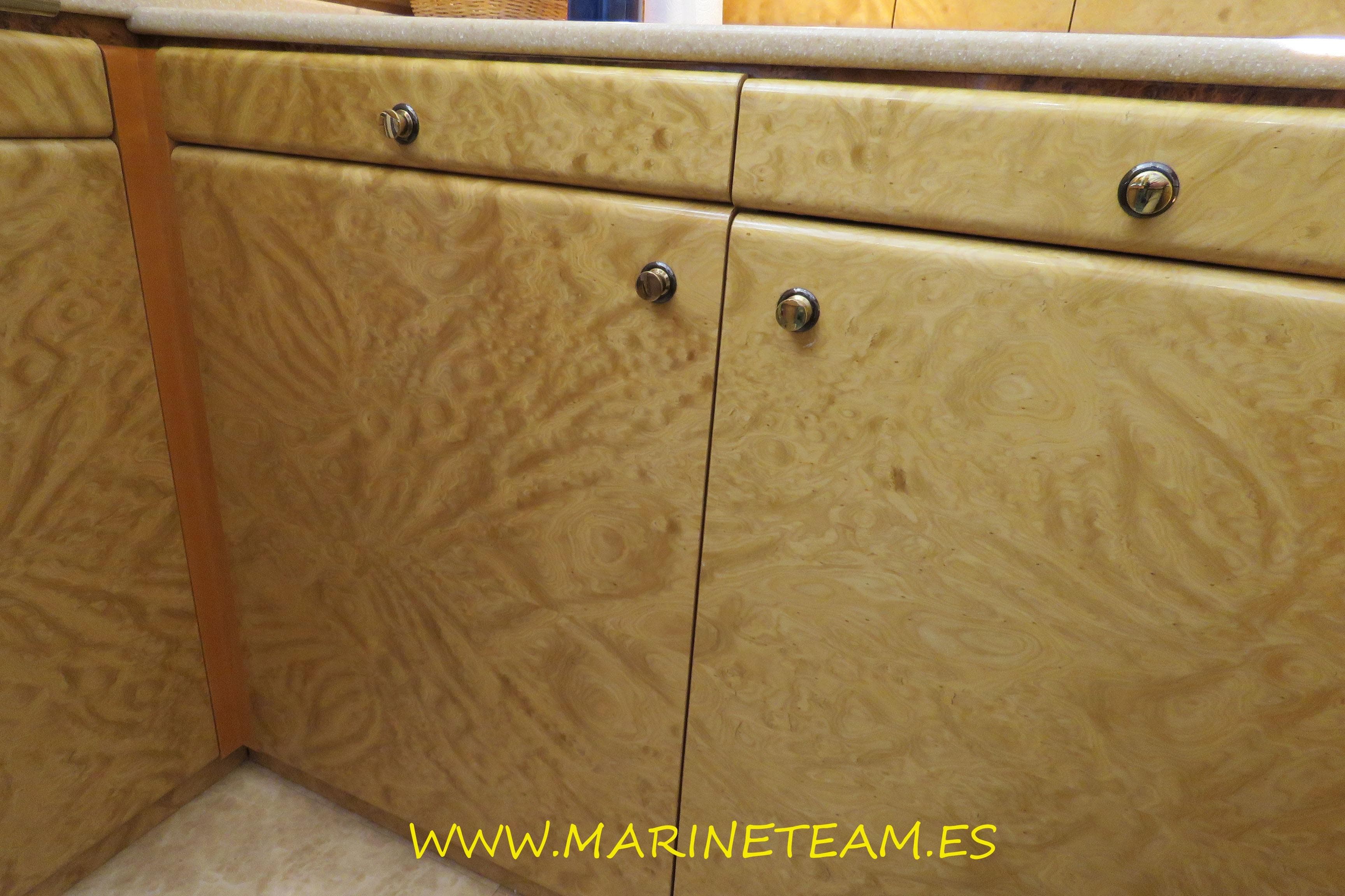 Wooden cabinet doors with unique grain pattern, featuring metal knobs.