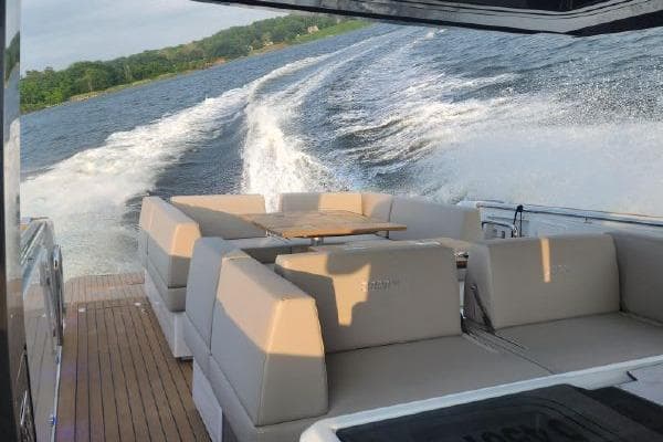 2023 Fjord 41 XL yacht cruising on a scenic waterway, featuring luxurious seating.