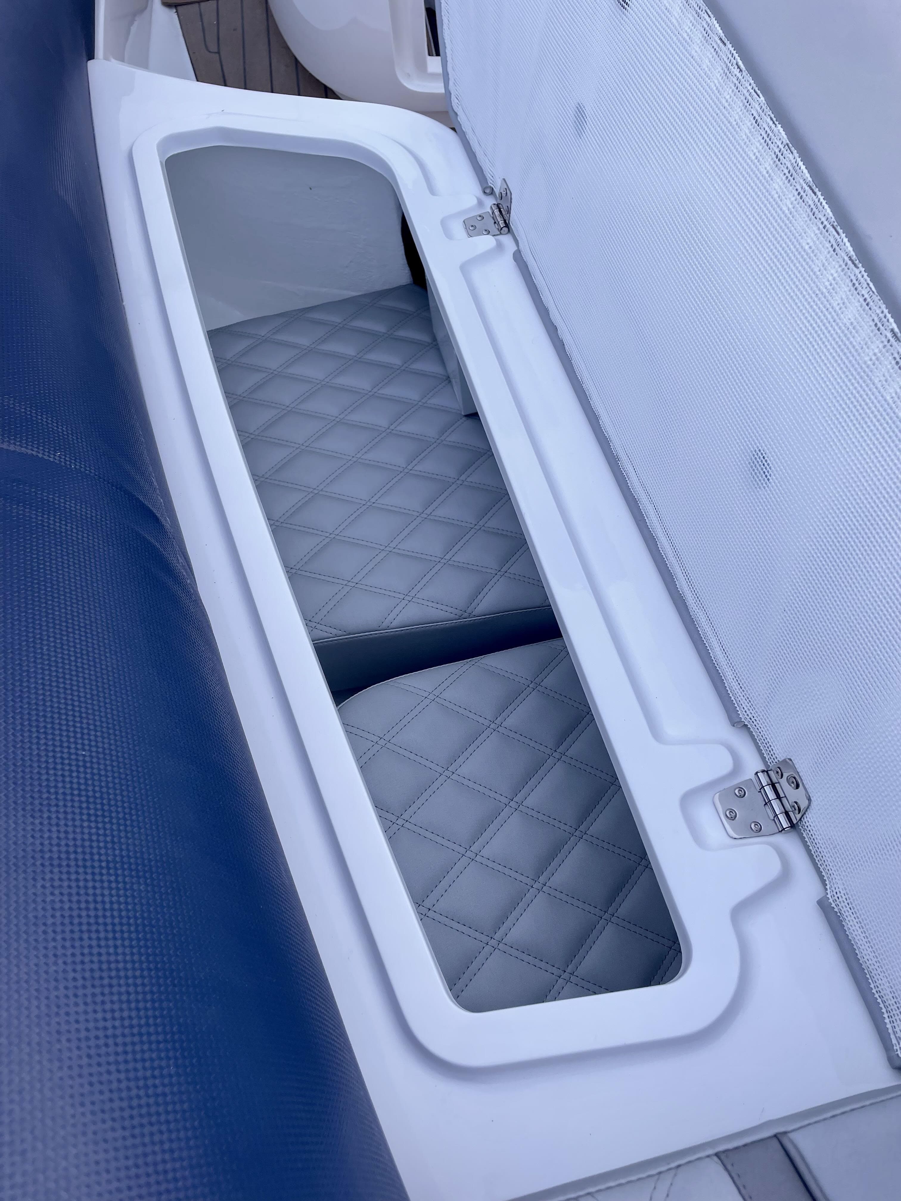 2024 Cobra Ribs Nautique 8.2m boat storage compartment with quilted interior design.