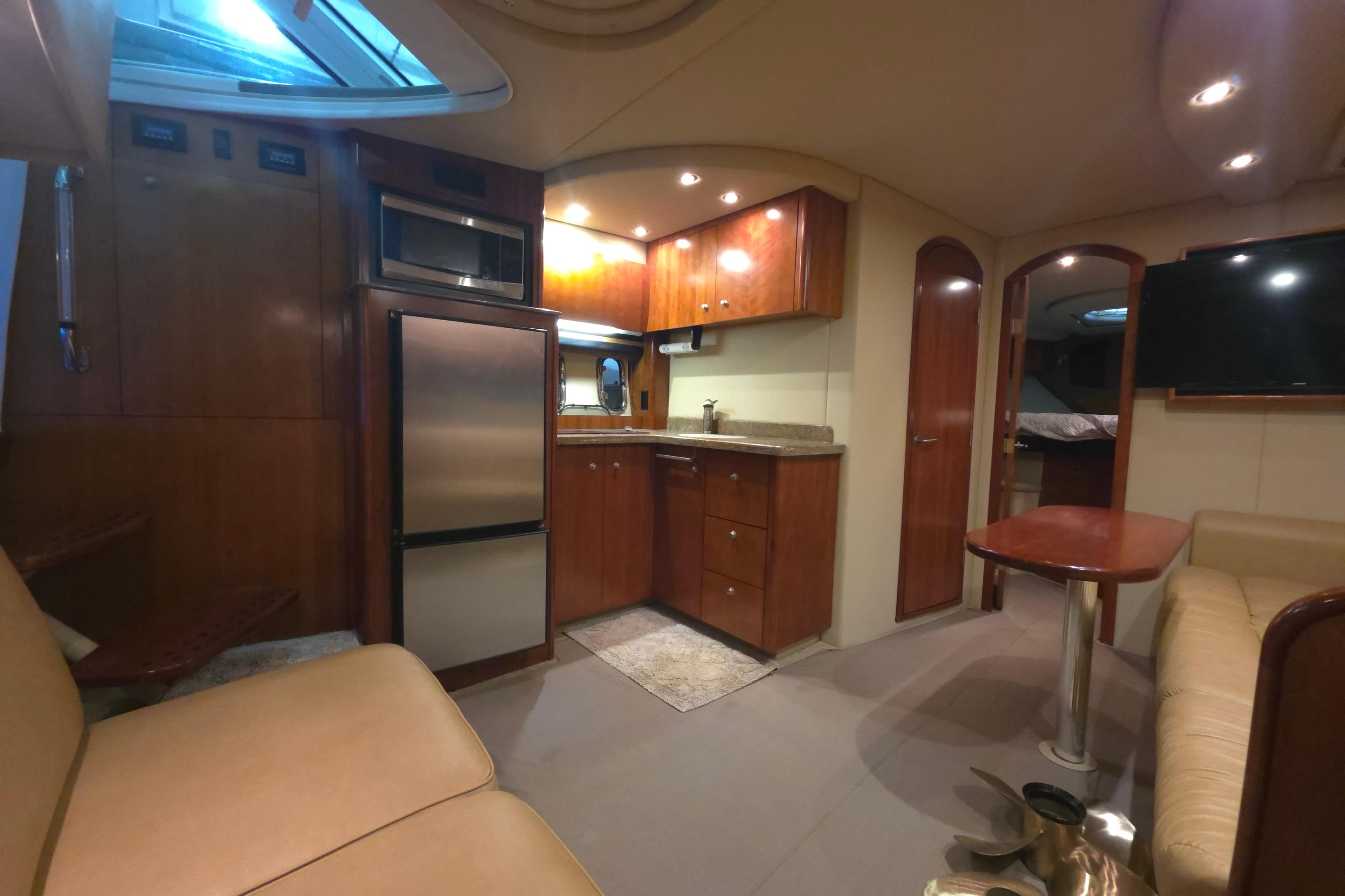 Luxurious interior of 2008 Cruisers Yachts 390 Sports Coupe with modern kitchen and seating area.