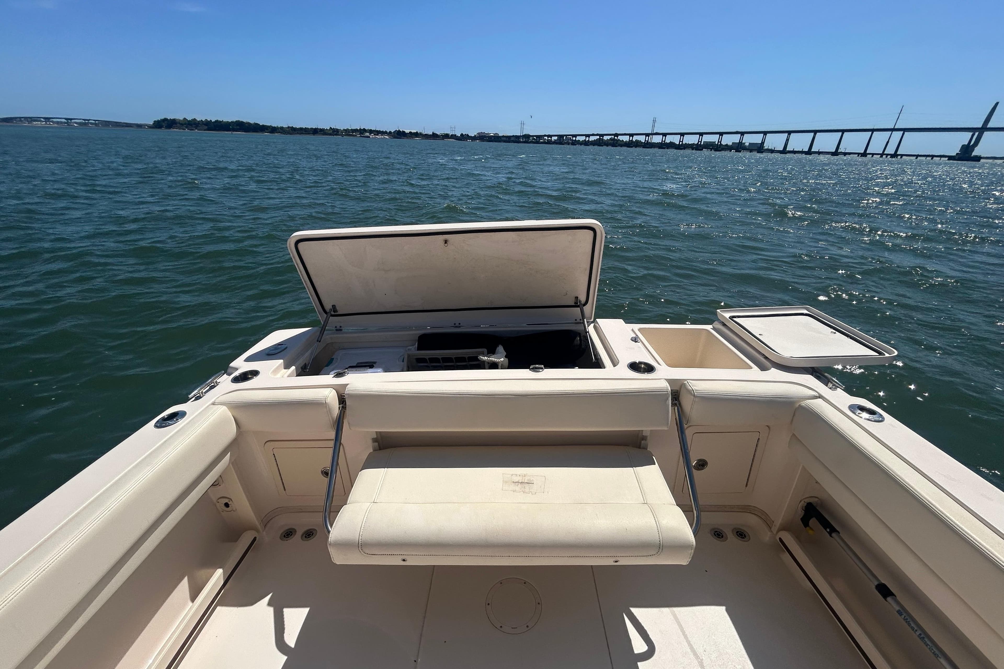 Grady-White Gulfstream 232 boat interior with open storage, on calm water near a bridge.