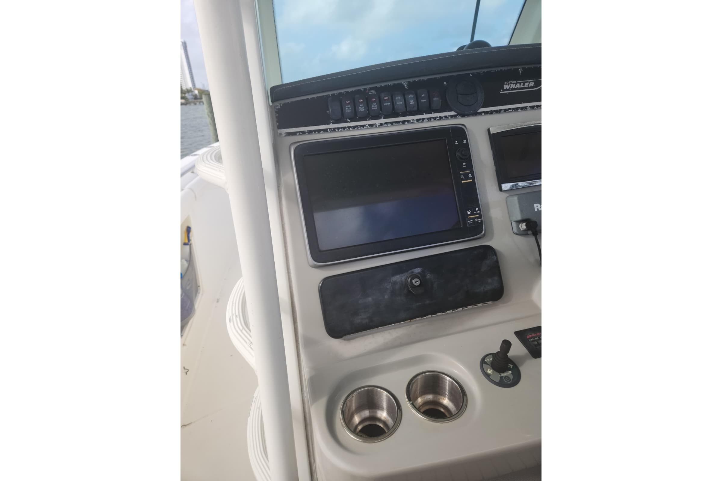 Control panel of a 2014 Boston Whaler 350 Outrage boat with navigation equipment.