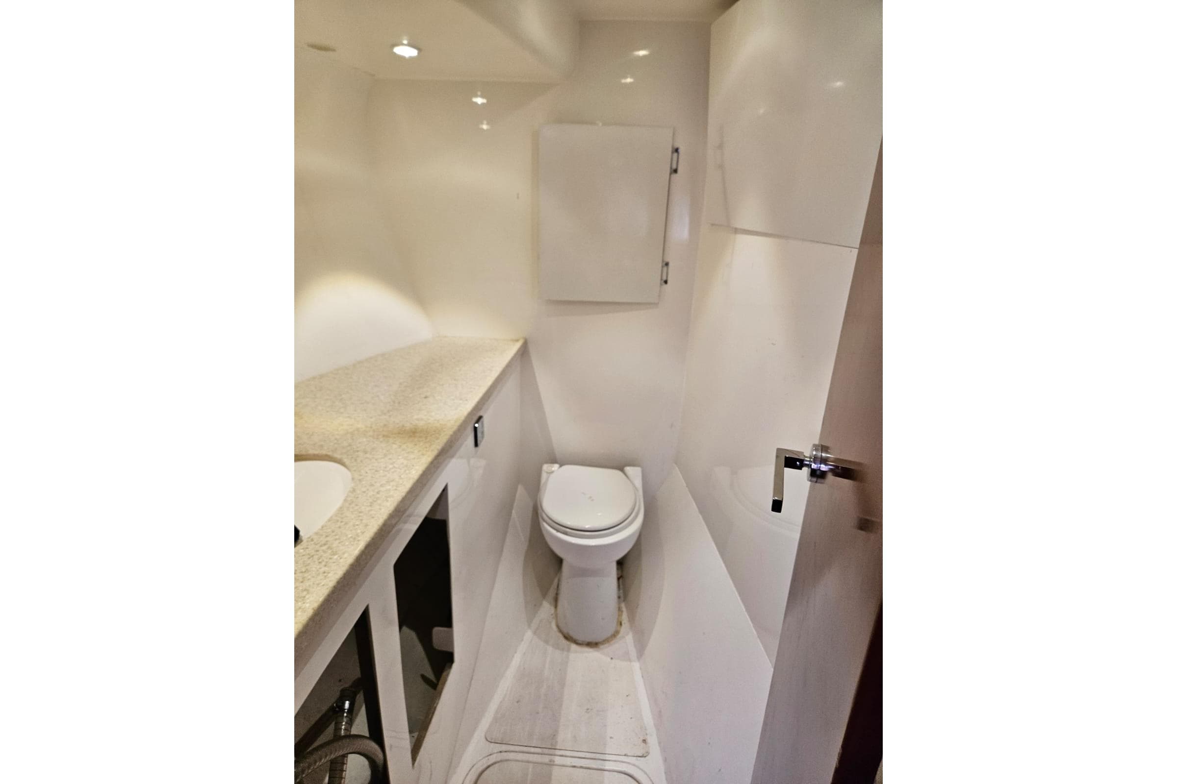 Compact modern bathroom in a 2016 Dean 50 model yacht, featuring sleek fixtures and lighting.
