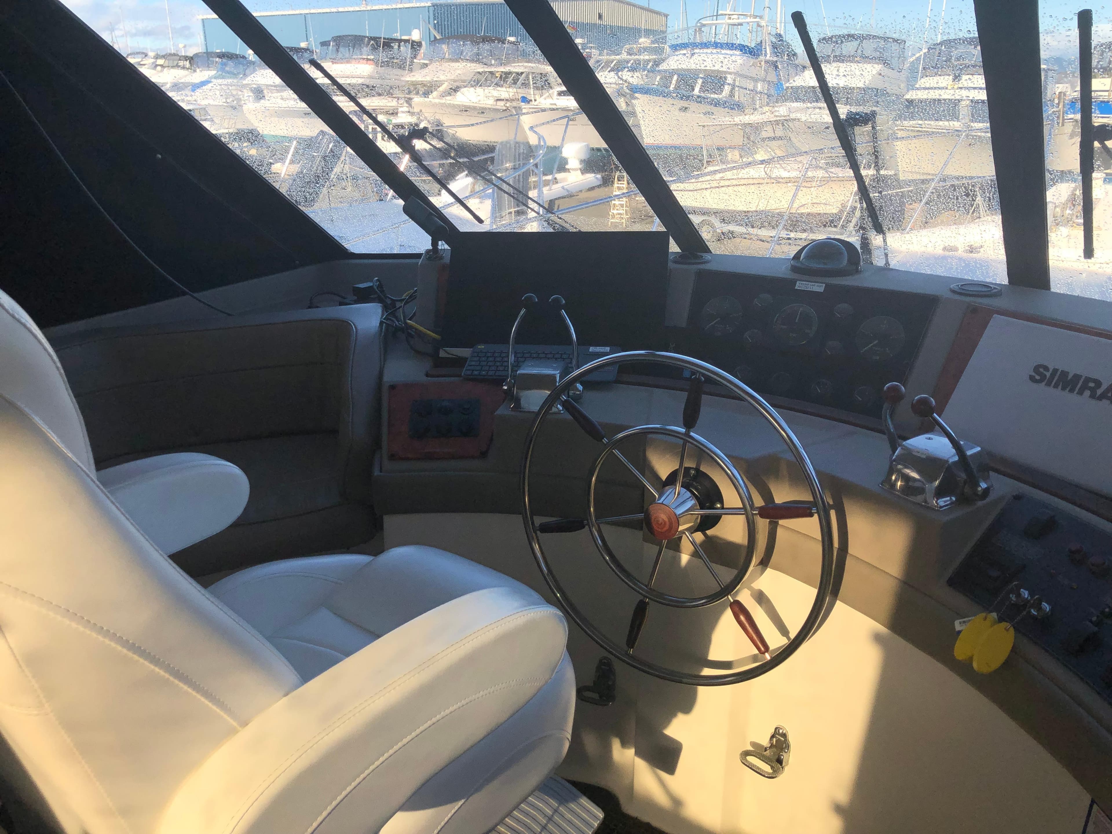 1996 Bayliner 4788 Pilot House Motoryacht helm with steering wheel and navigation equipment.