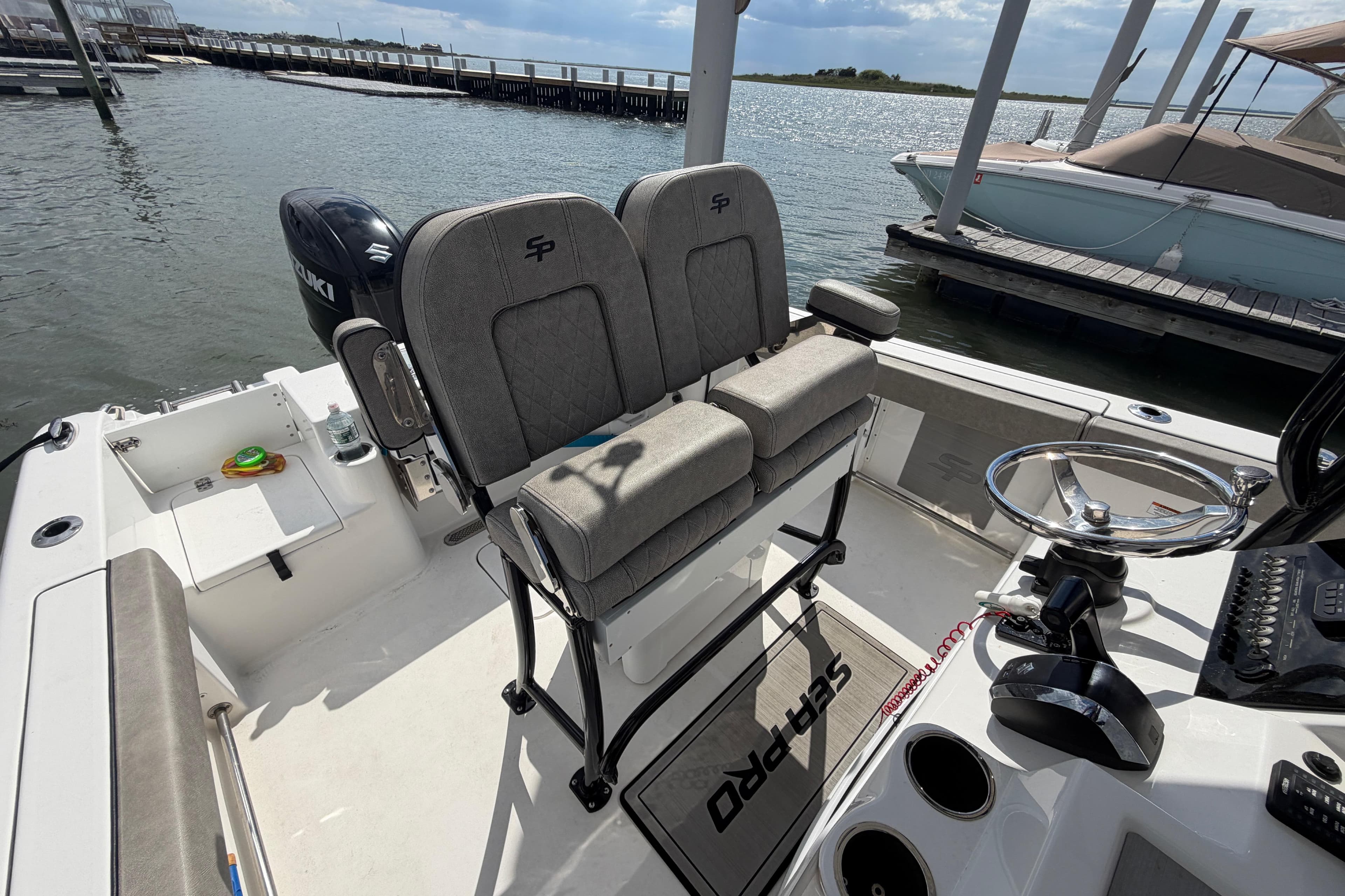 2022 Sea Pro 219 Deep V CC boat interior with dual seats and steering wheel.
