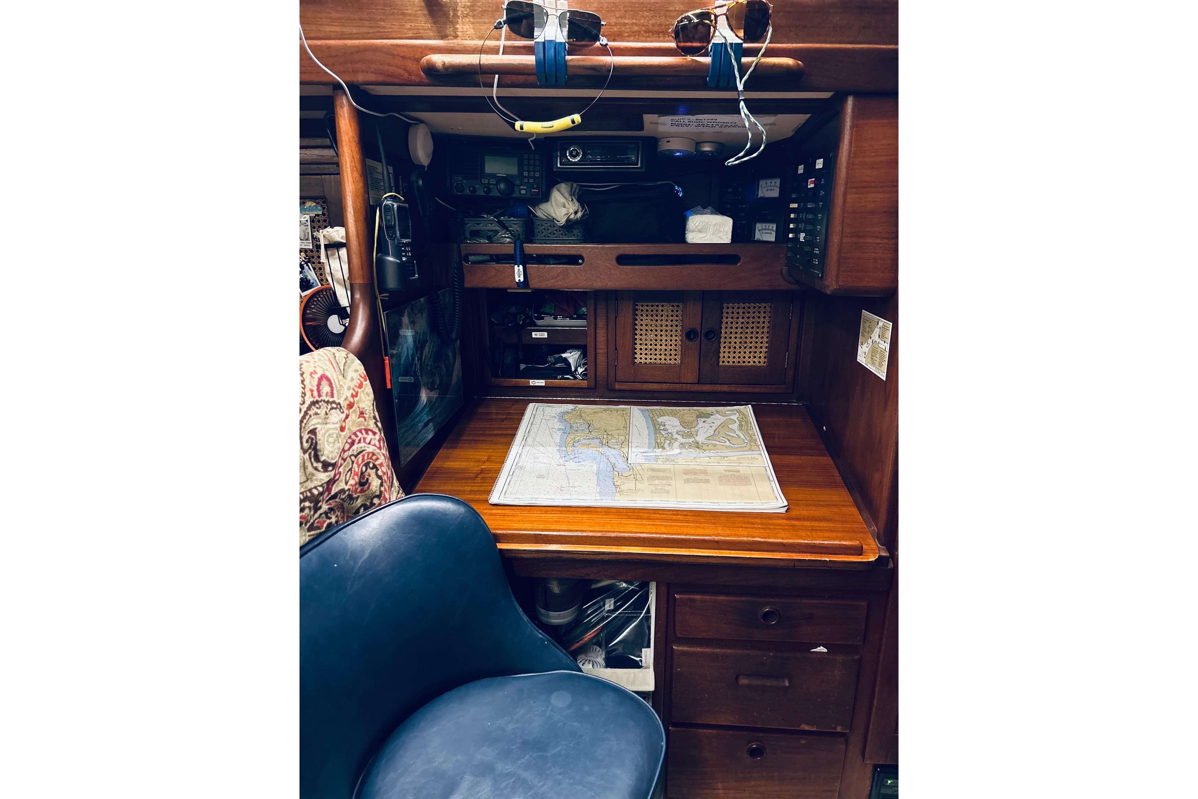 Navigation station inside 1983 Tartan 42 sailboat with map and equipment.