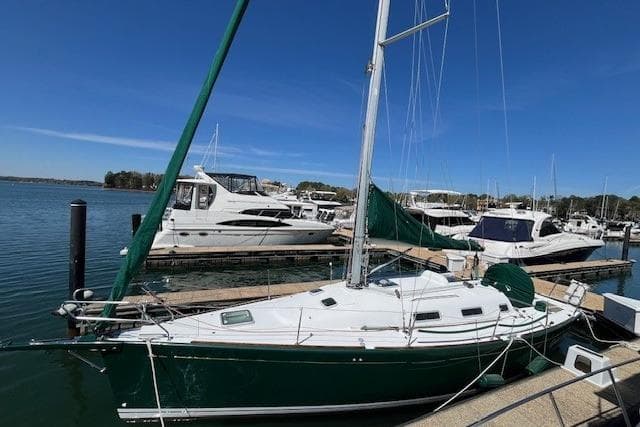 2005 Beneteau First 36.7 sailboat docked at marina under clear blue sky.