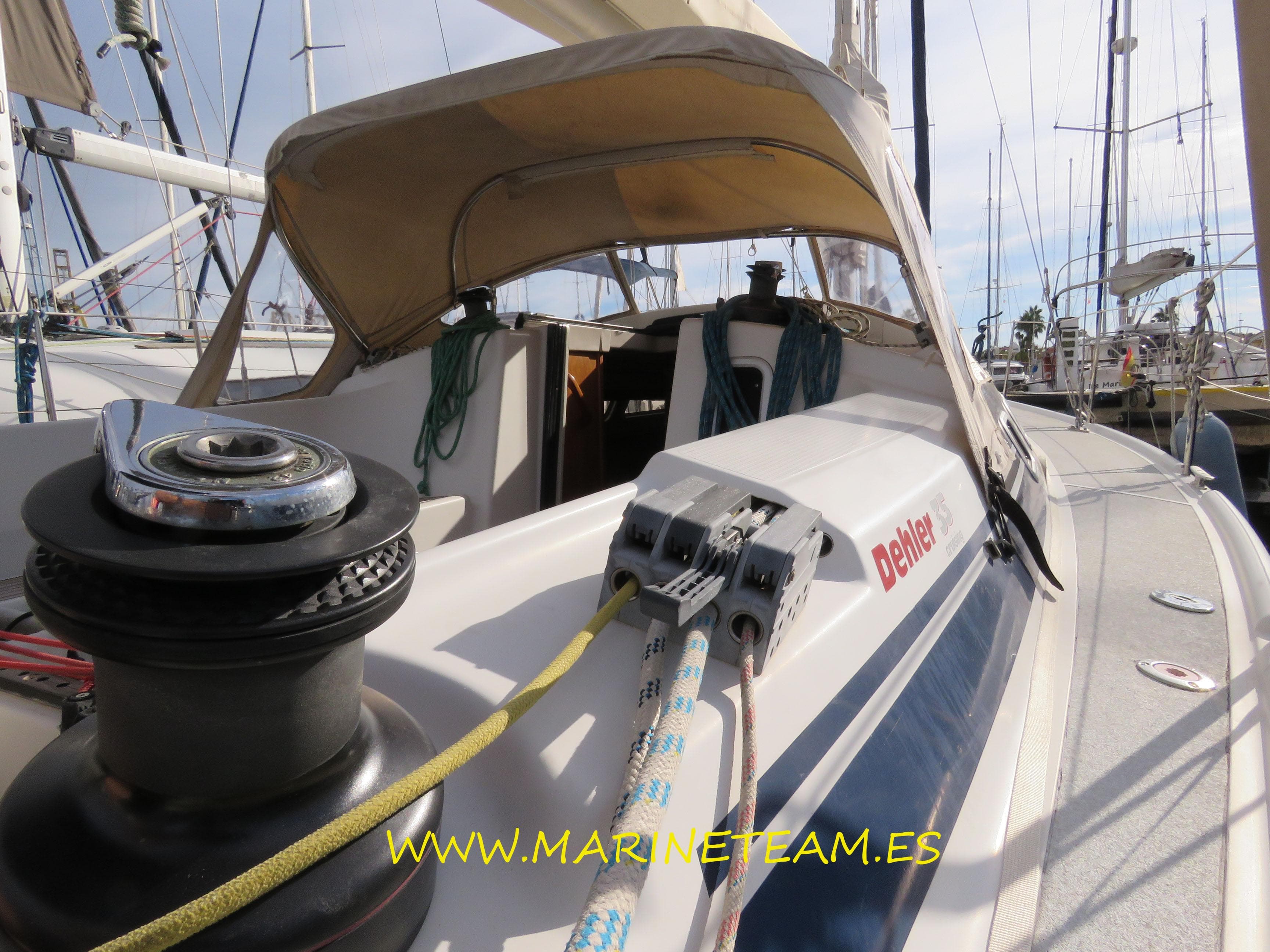 1997 Dehler 35 sailboat deck with winch and ropes, docked at marina.