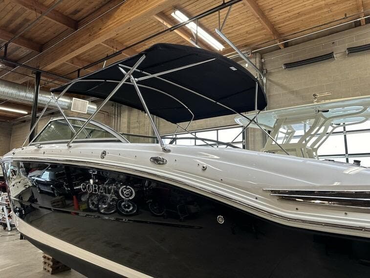 2011 Cobalt 296 boat with canopy in a warehouse setting.