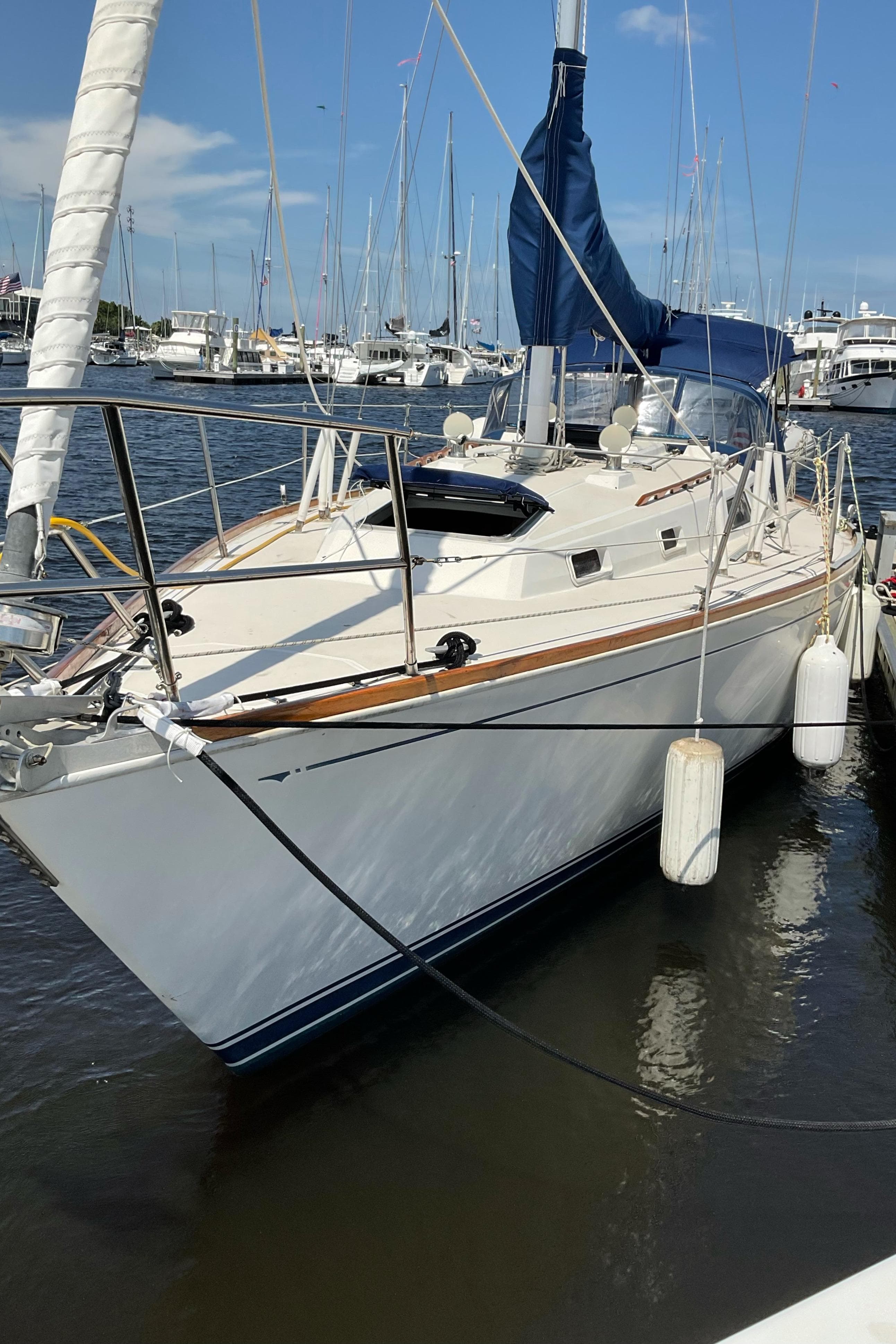 1989 Sabre 34 MK II sailboat docked in a marina, surrounded by other boats.