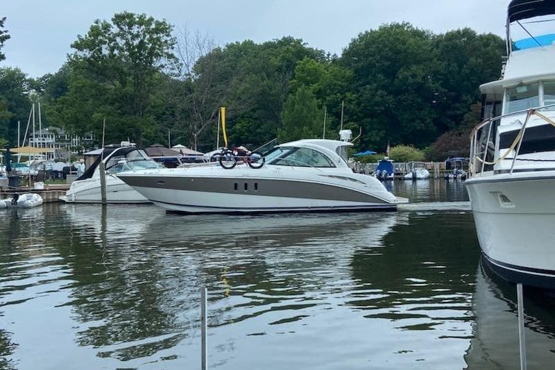2008 Cruisers Yachts 390 Sports Coupe docked in a serene marina setting.