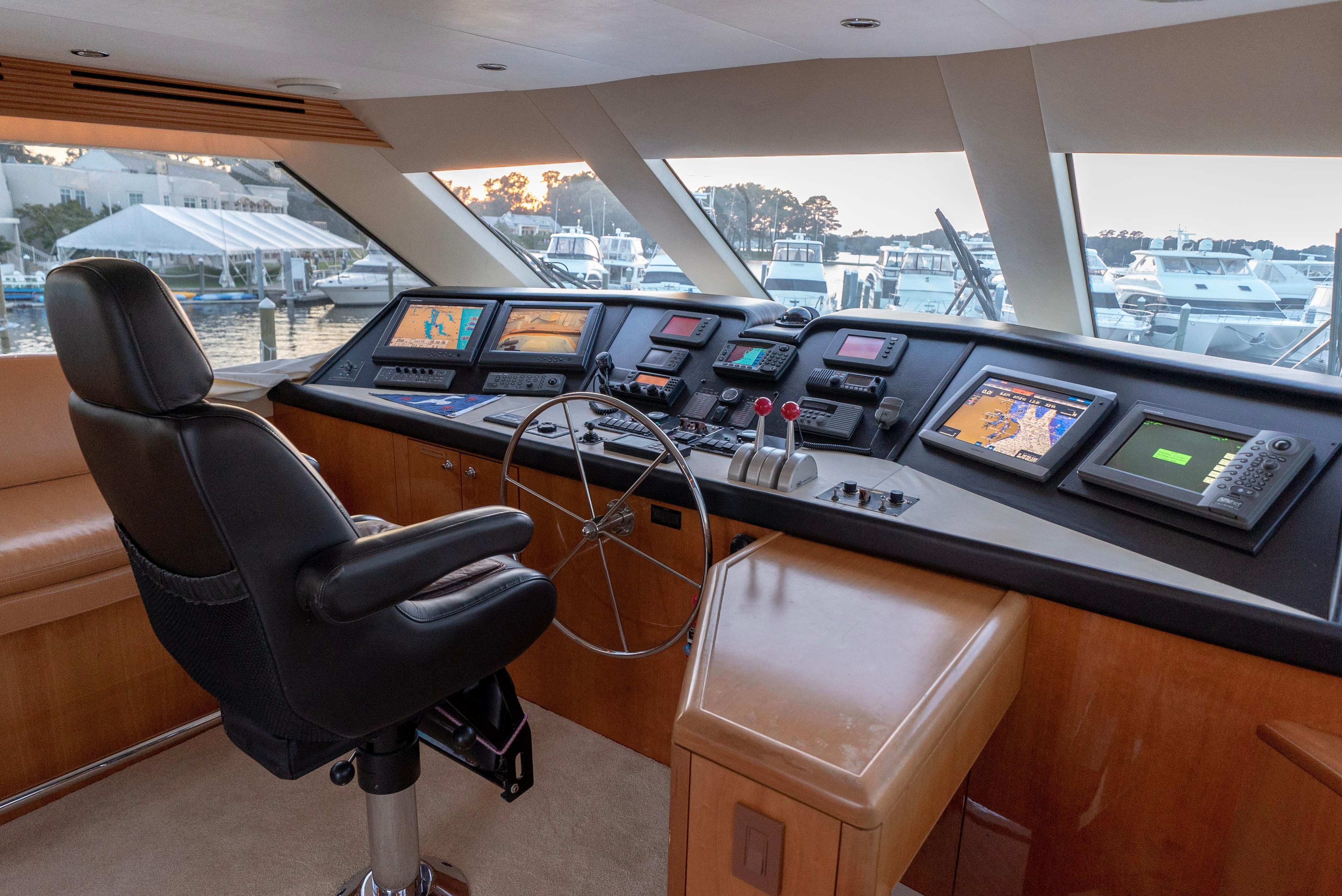 Helm station of 2003 Hatteras 70 Convertible yacht with advanced navigation systems.