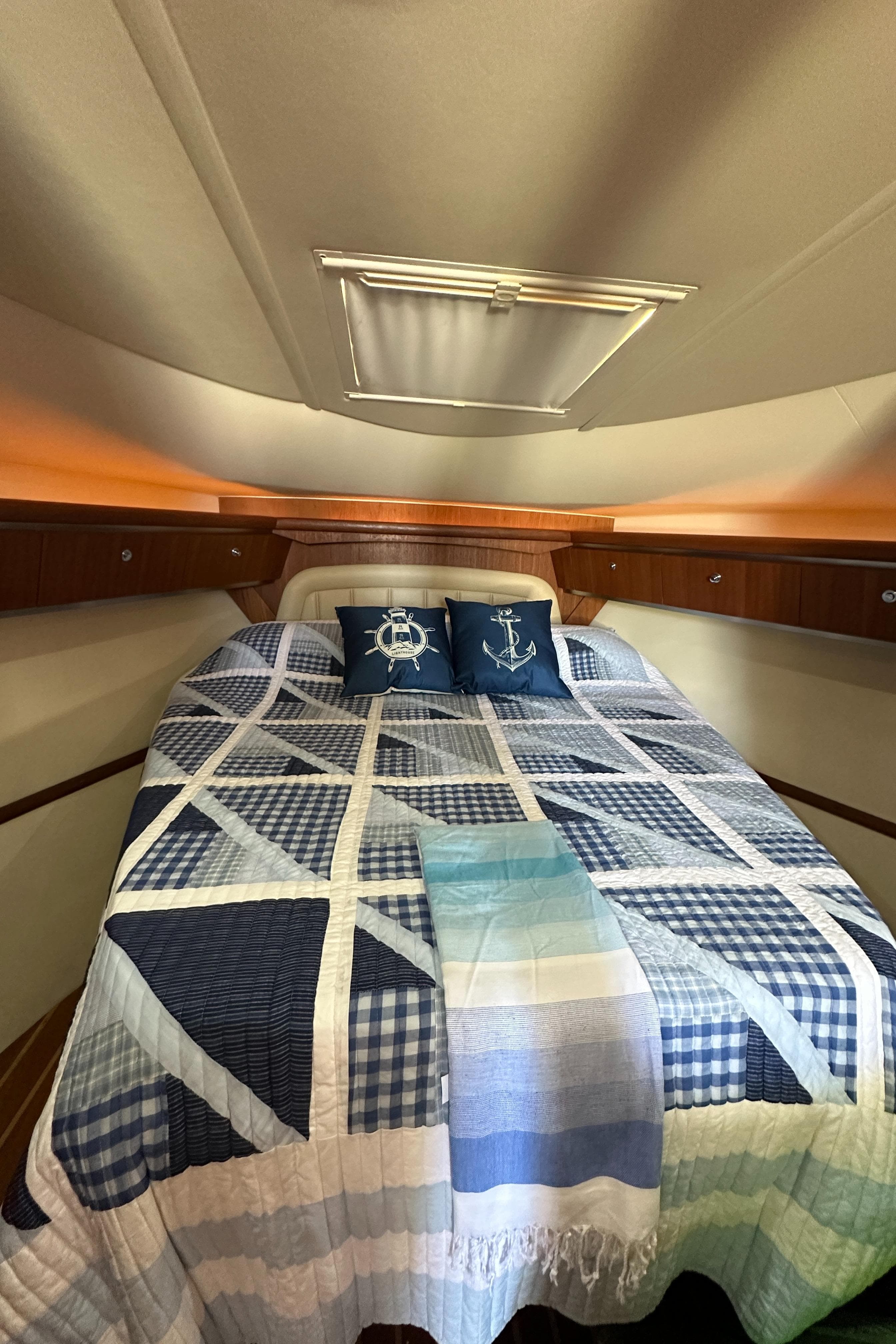 2004 Tiara Yachts 3600 Sovran cabin with nautical-themed bedding and pillows.