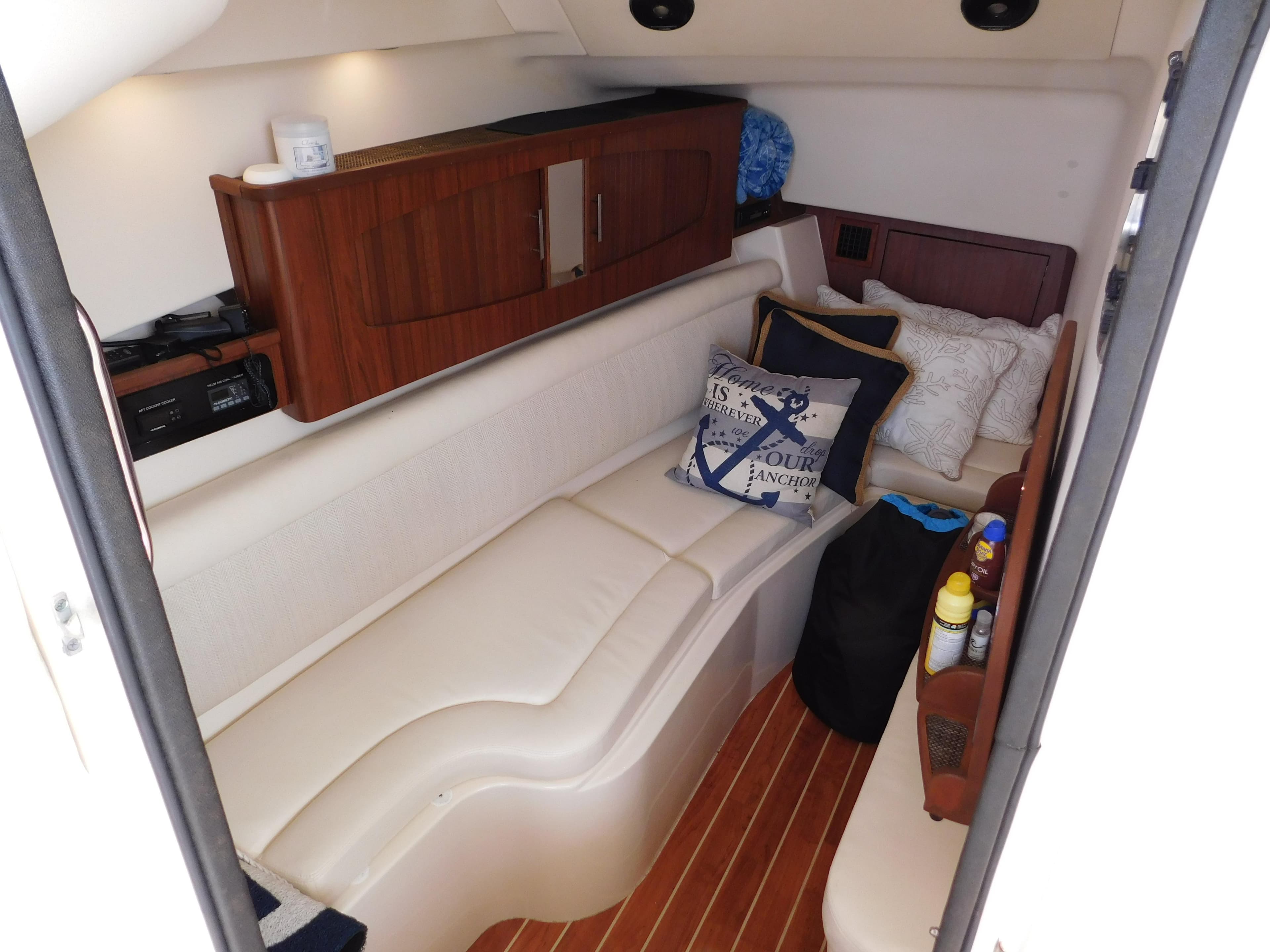 2018 Grady-White Freedom 375 cabin interior with cozy seating and wooden cabinetry.