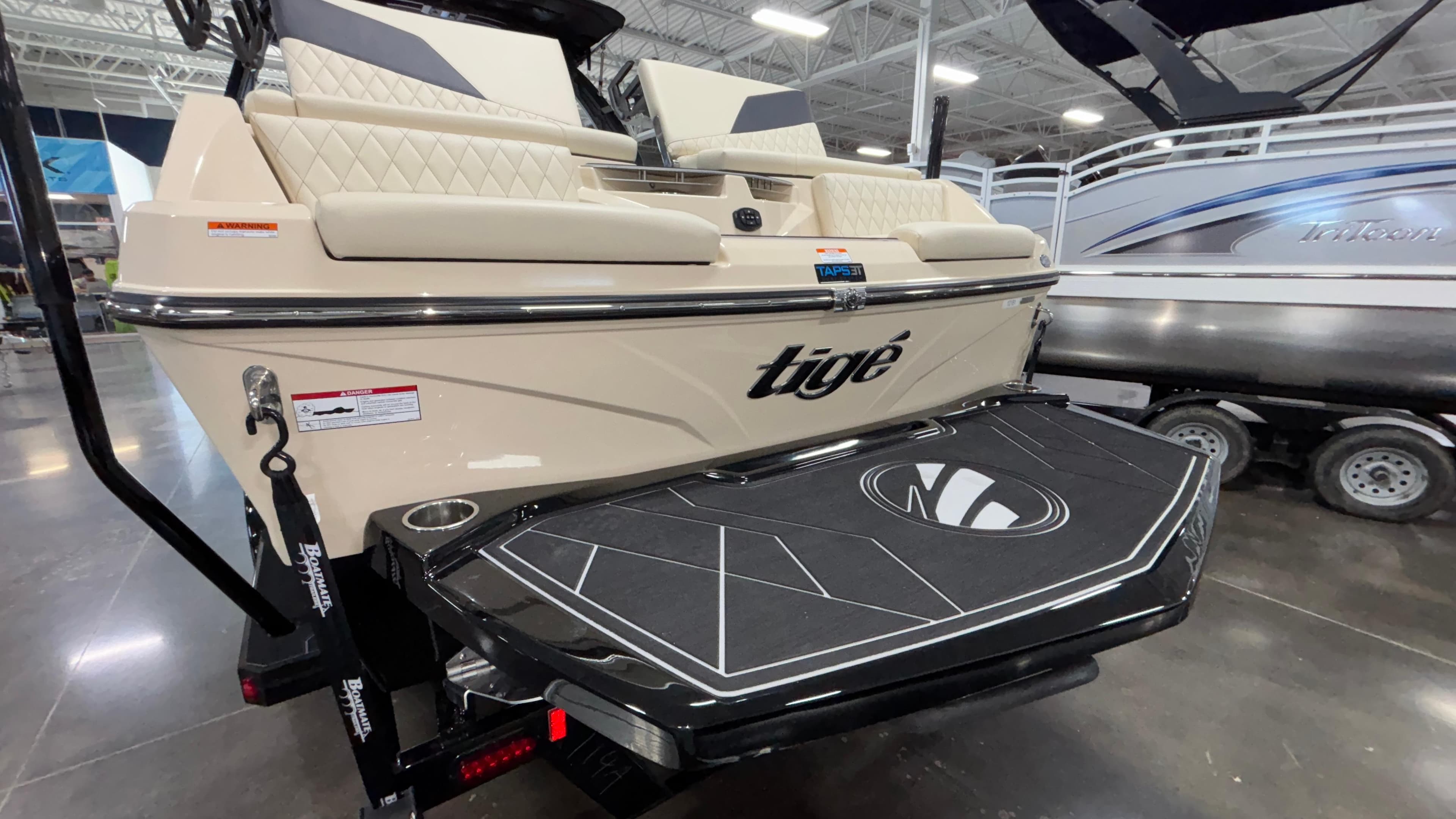 2025 Tigé Z5 boat rear view in showroom, featuring sleek design and swim platform.