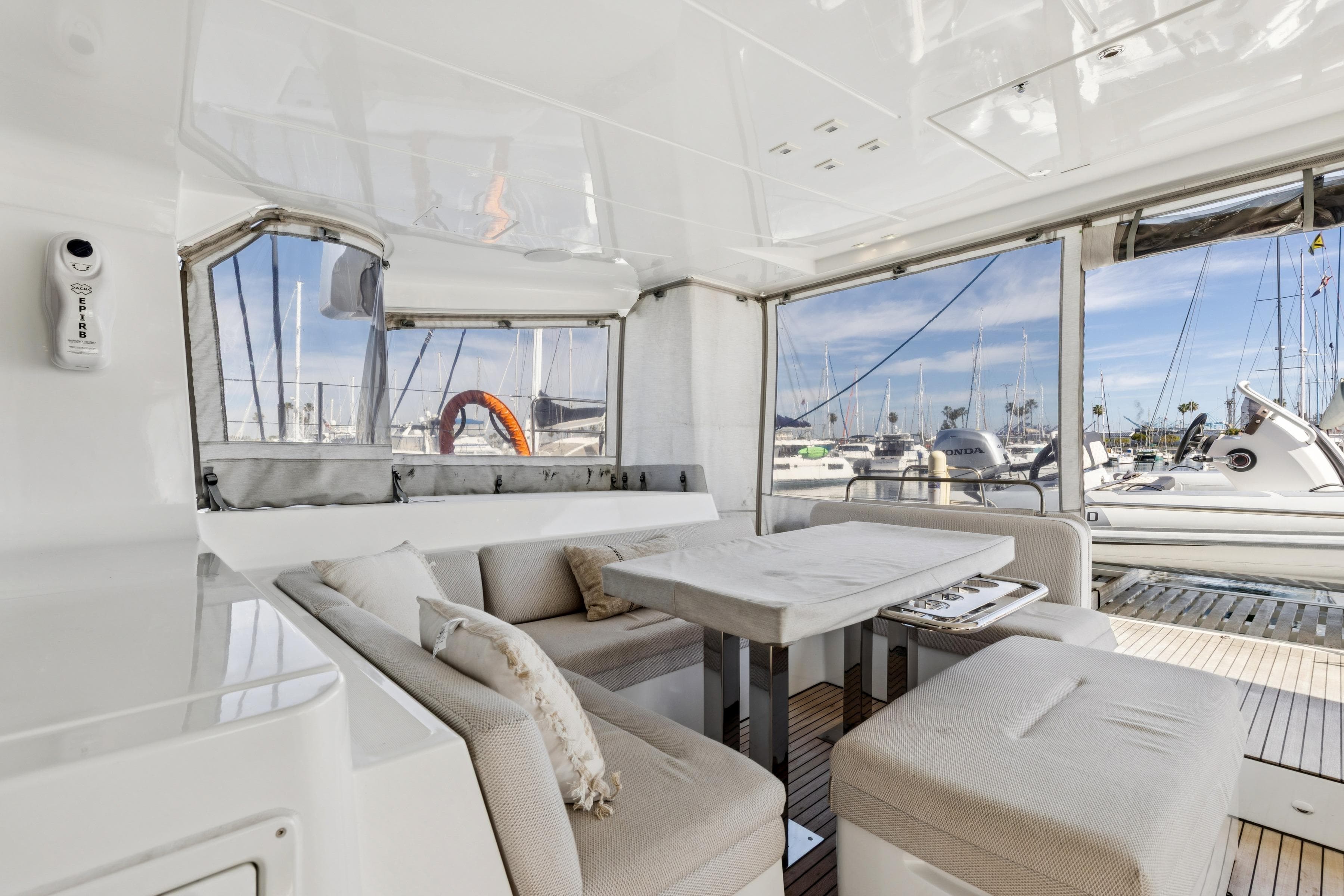 Luxurious 2022 Lagoon 52 F yacht interior with elegant seating and marina view.
