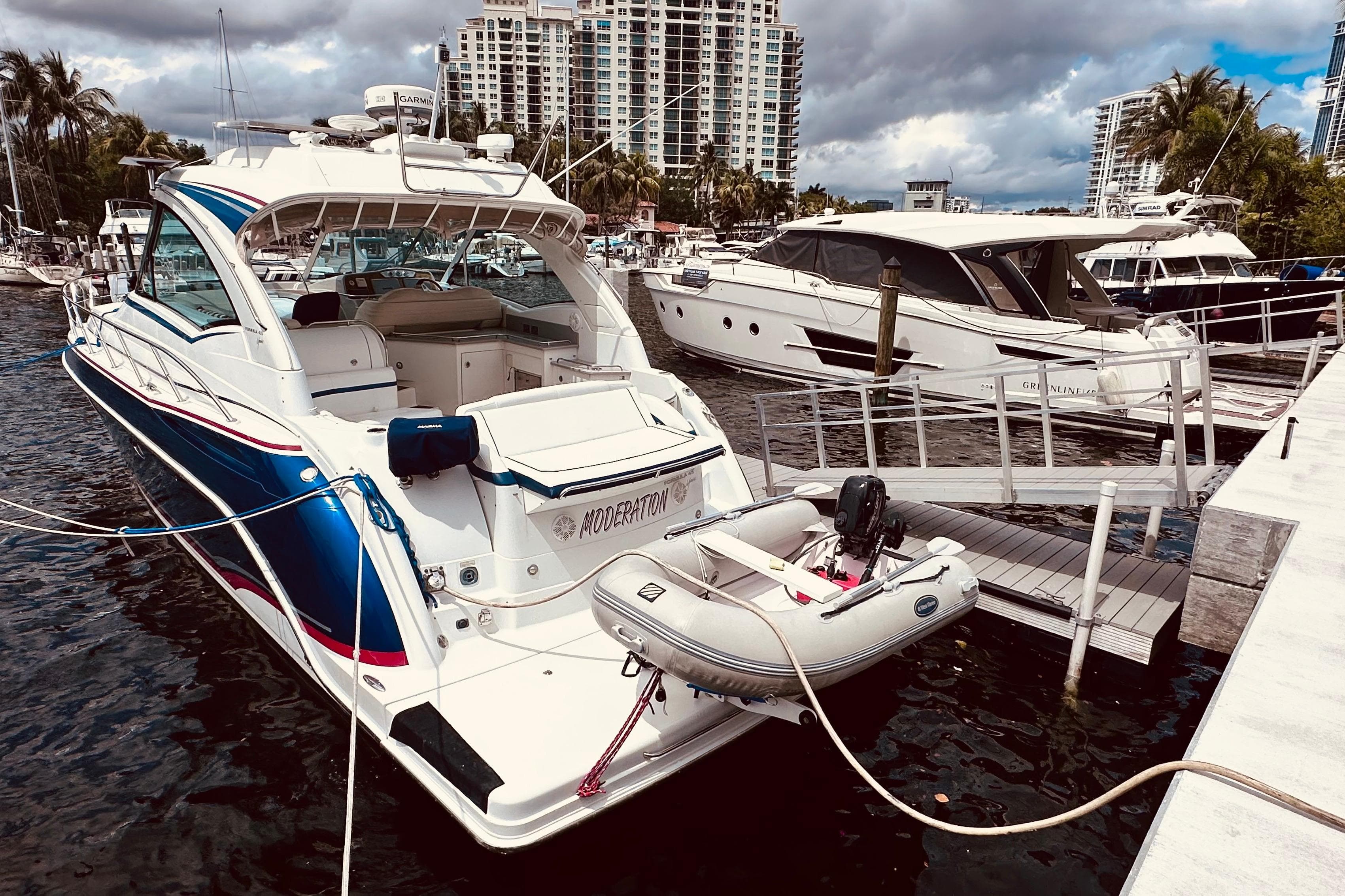 2012 Formula 45 Yacht docked with inflatable boat, surrounded by other yachts.