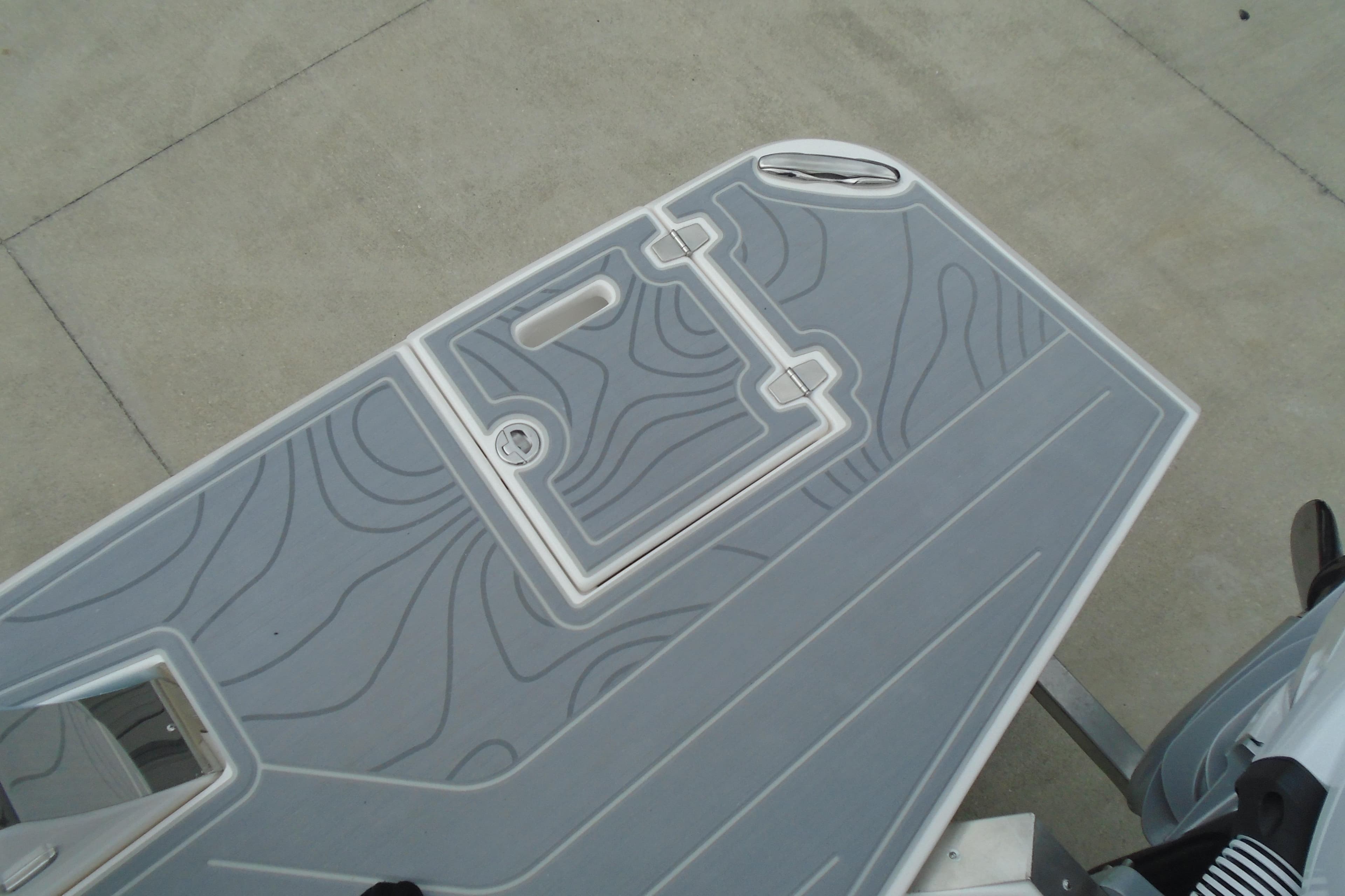 2026 Regal LX36 boat deck with textured gray surface and hatch.
