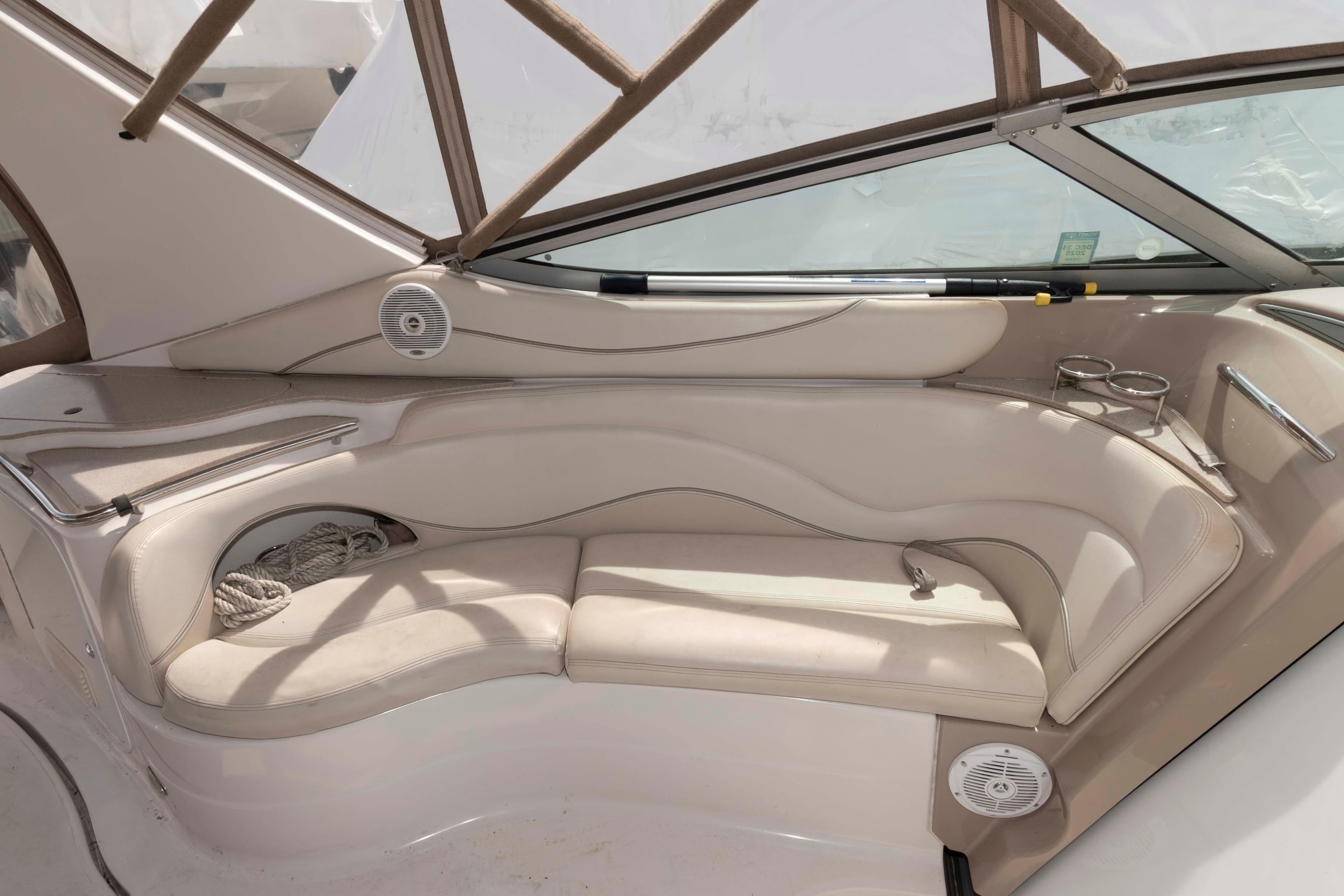 2007 Larson Cabrio 370 boat interior with beige seating and cup holders.