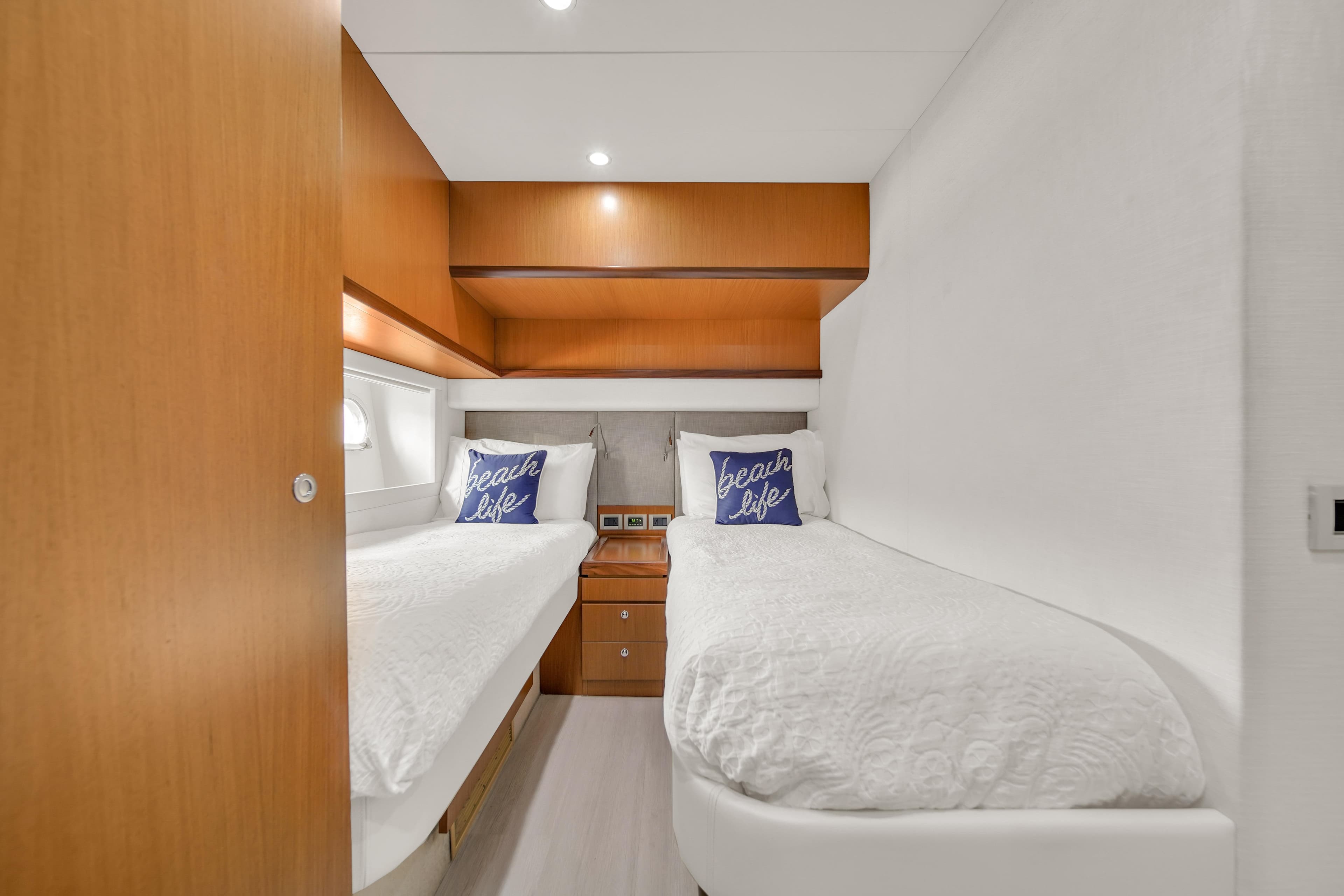 Luxurious twin cabin in 2011 Ferretti Yachts 660, featuring modern wood accents.