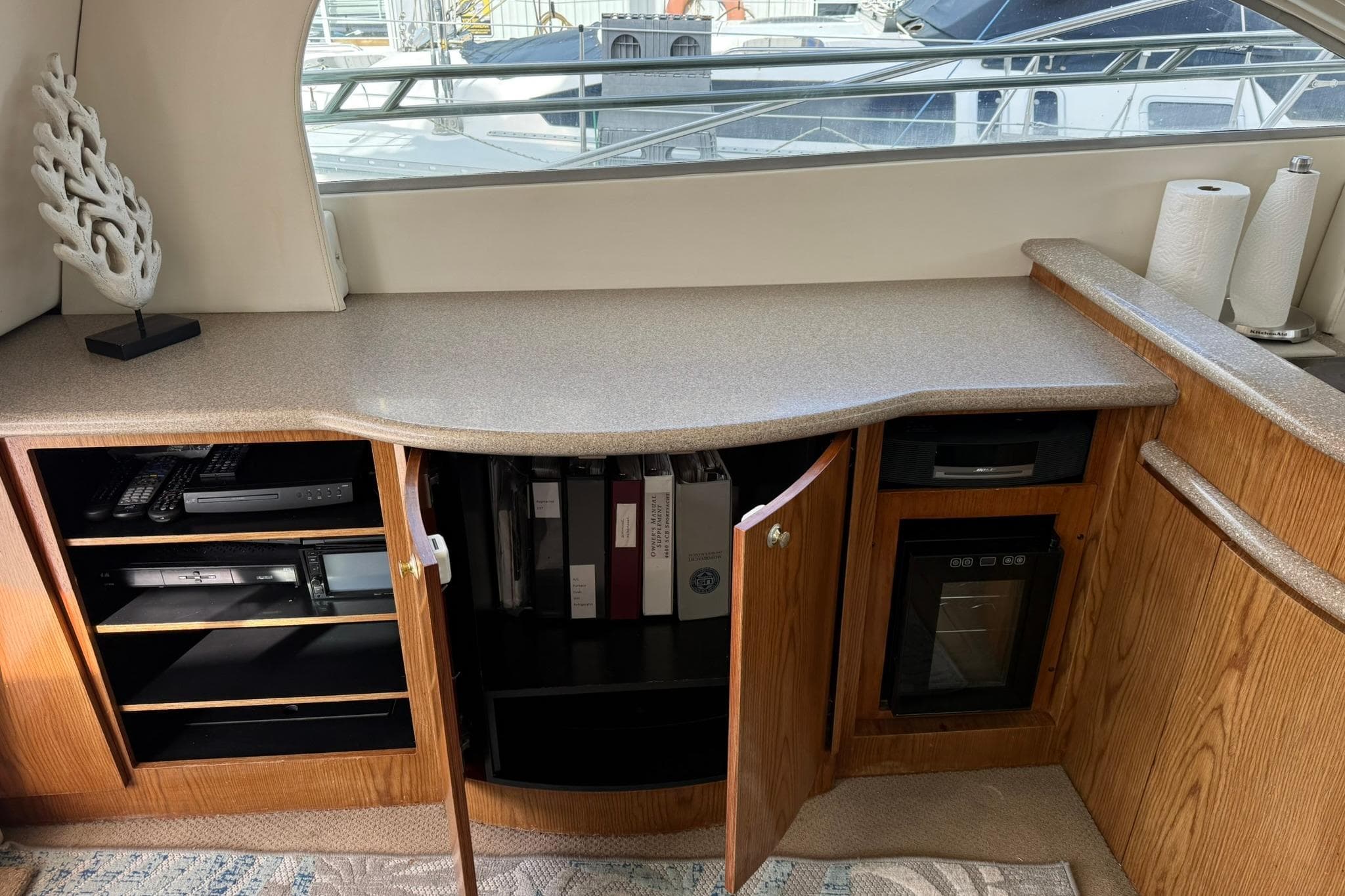 1999 Maxum 4600 SCB yacht interior with open cabinets, electronics, and decorative items.