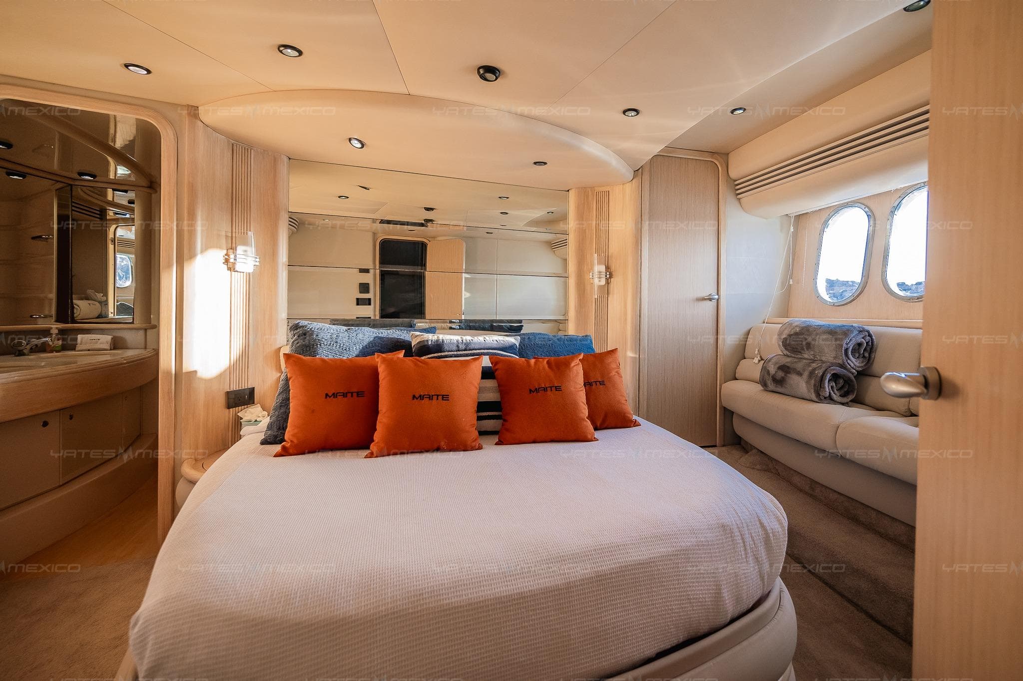 Luxurious 2004 Azimut 68 Plus yacht bedroom with elegant decor and plush bedding.