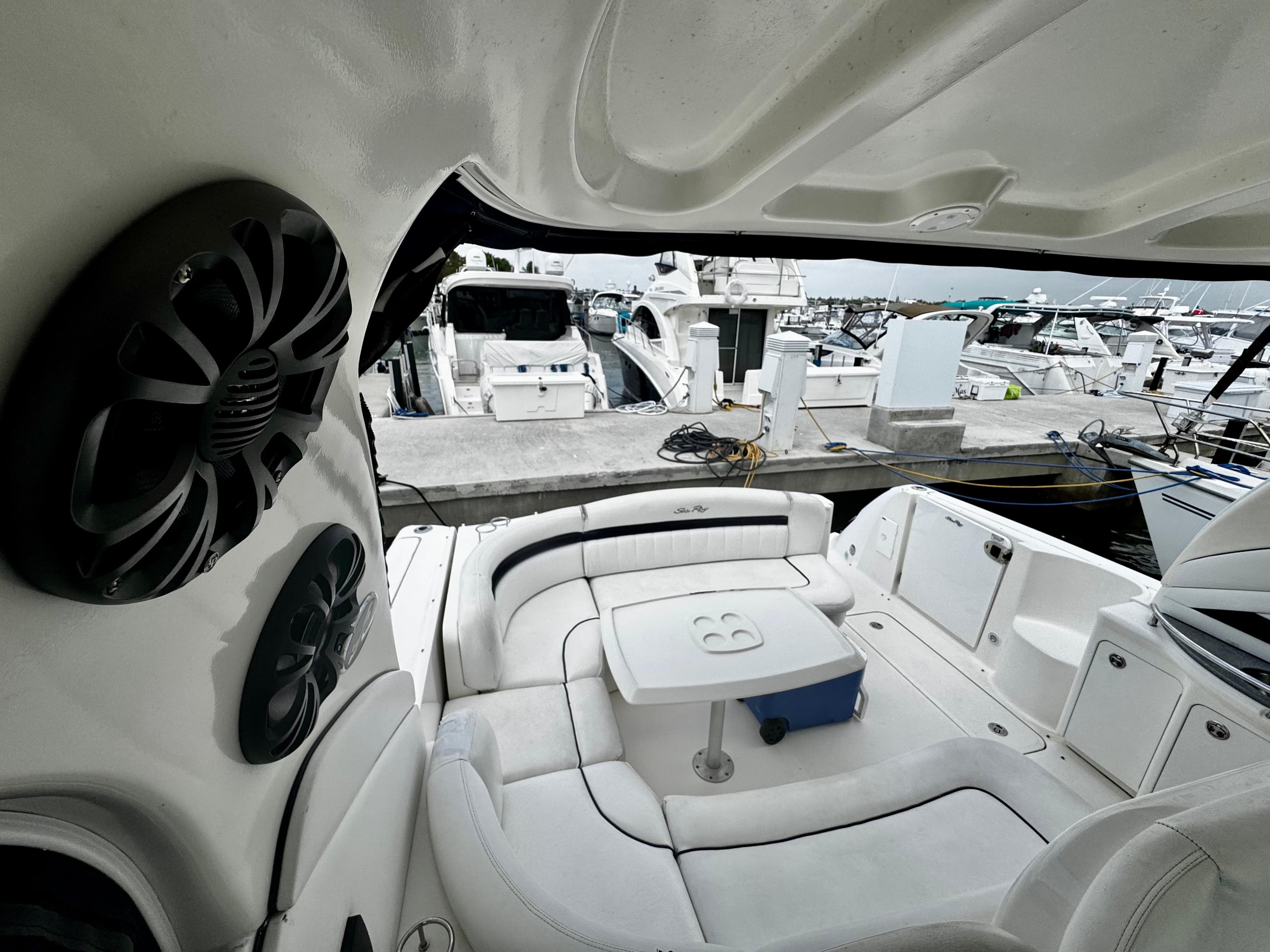 Interior view of 2007 Sea Ray 40 Sundancer yacht with white seating and marina backdrop.