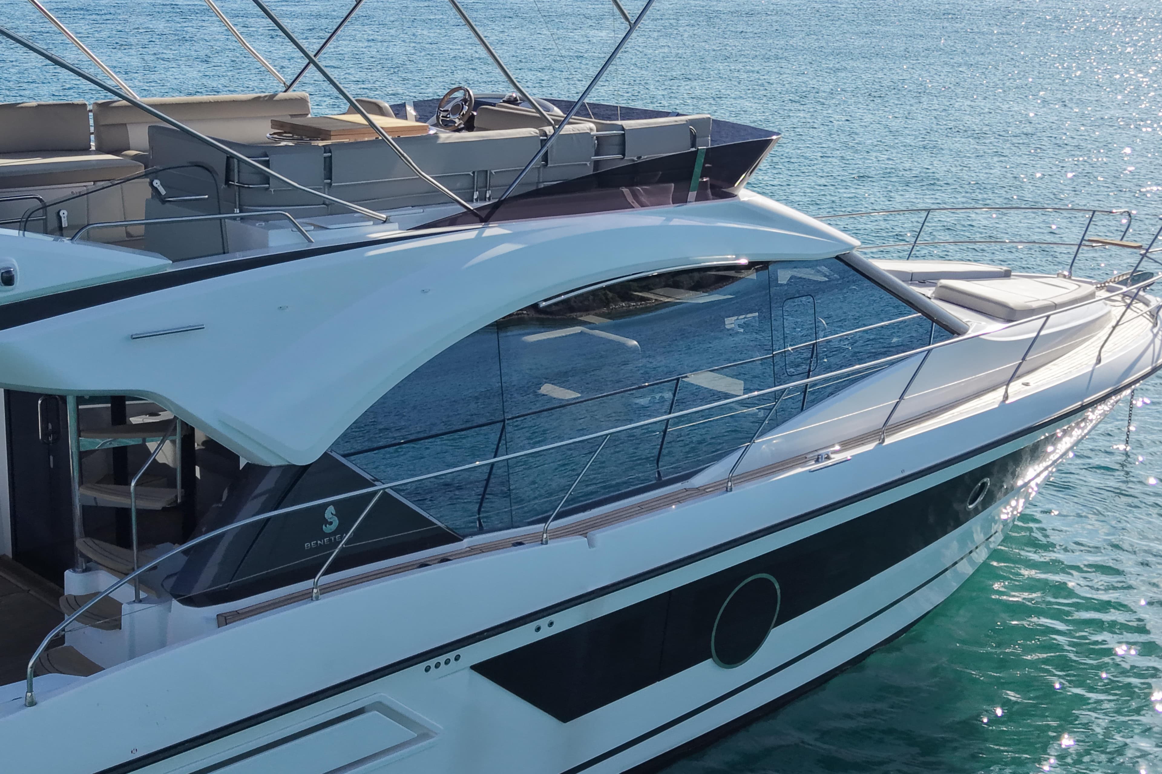 Luxury Monte Carlo 52 yacht, 2022 model, docked on serene blue waters.