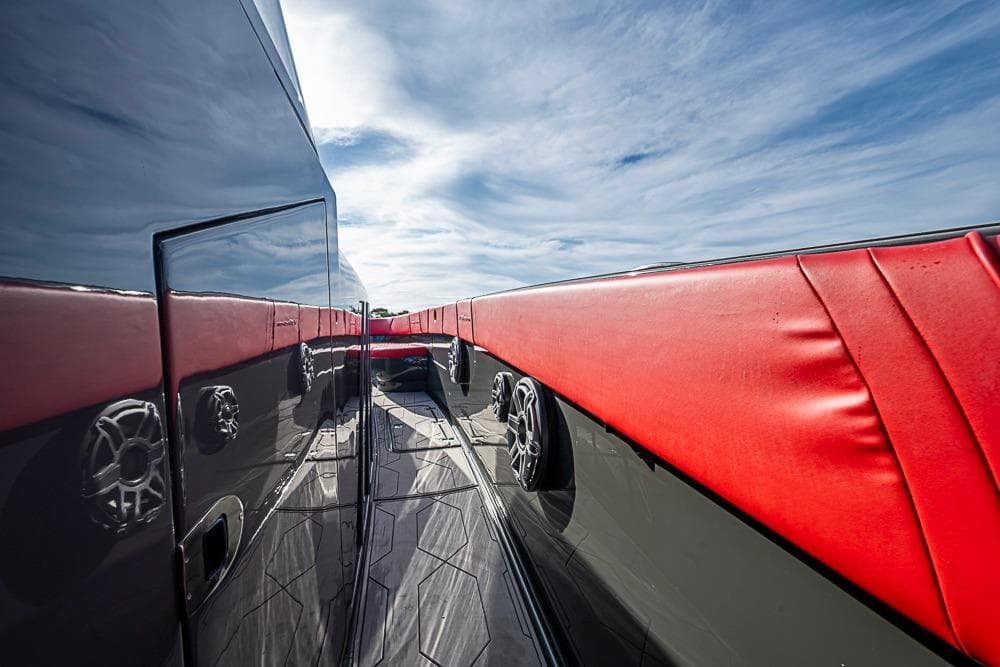 2021 Midnight Express 43 Solstice yacht with sleek design and red accents under blue sky.