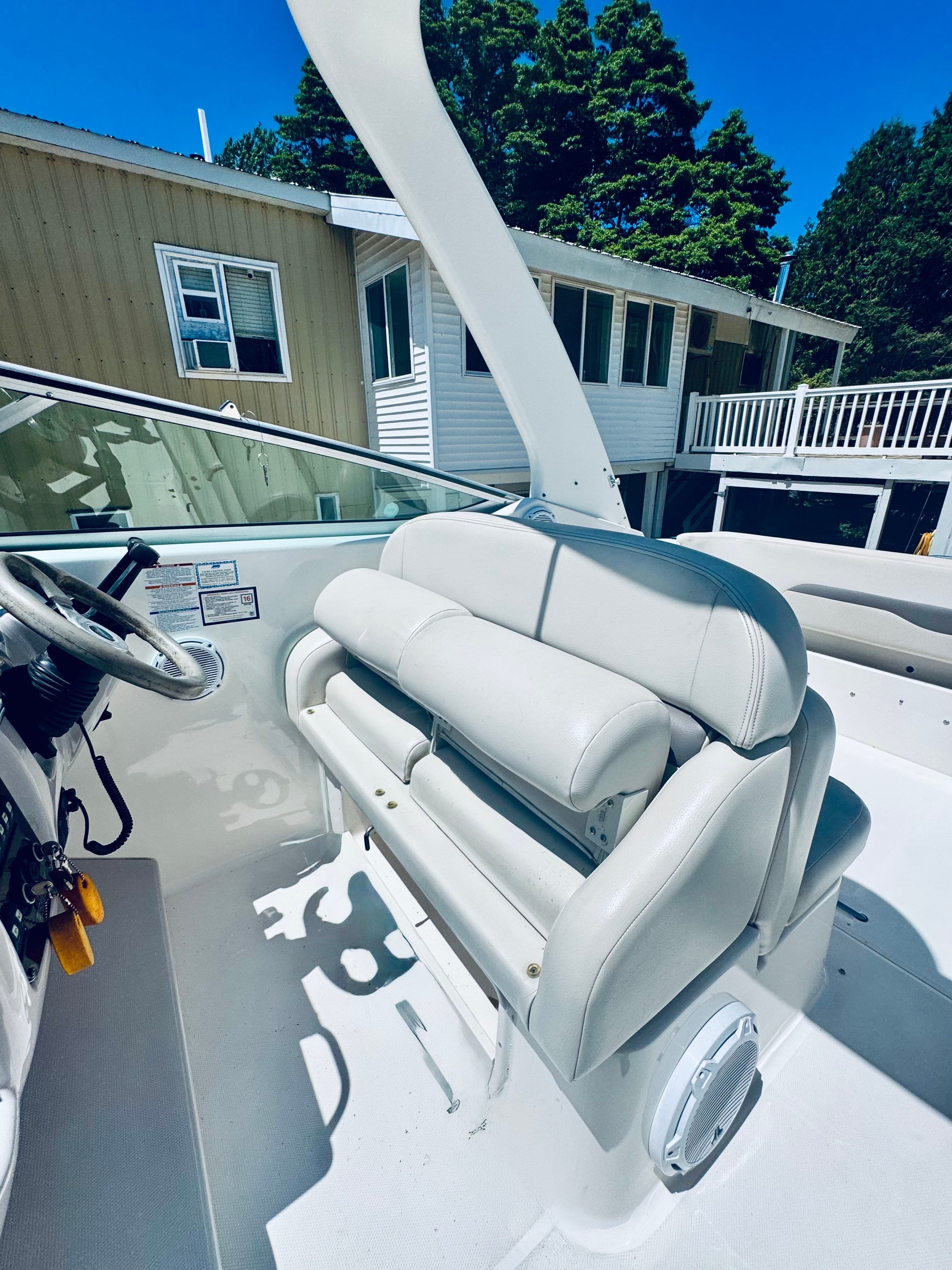 Interior of a 2005 Chaparral Signature 270 boat with white seating.