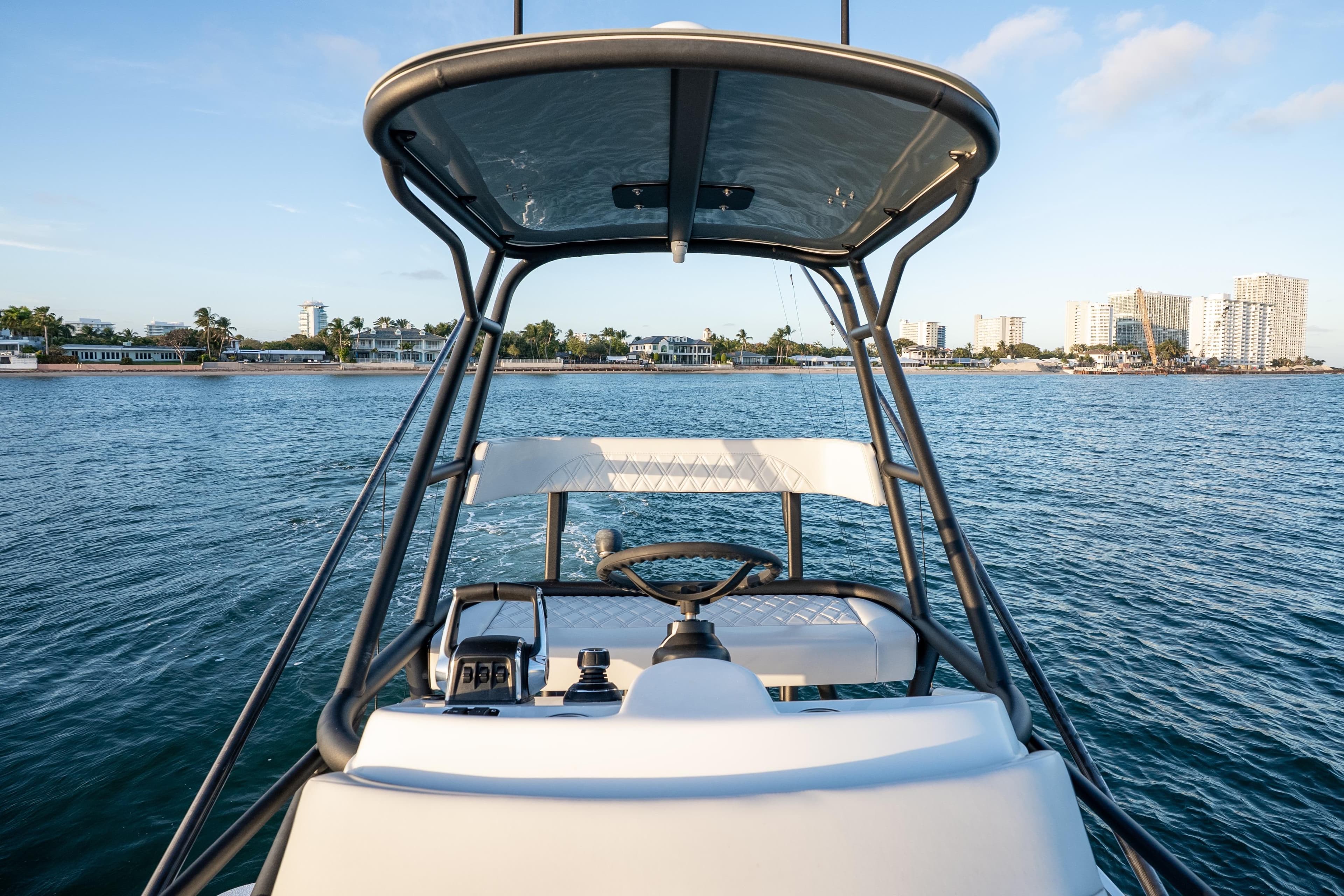 2023 Yellowfin 42 Offshore boat helm with ocean and city skyline view.