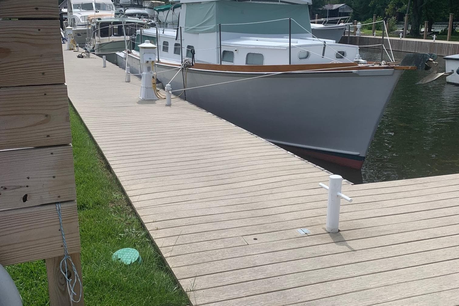 1963 Wiley Trawler docked at a marina, showcasing classic design and wooden accents.