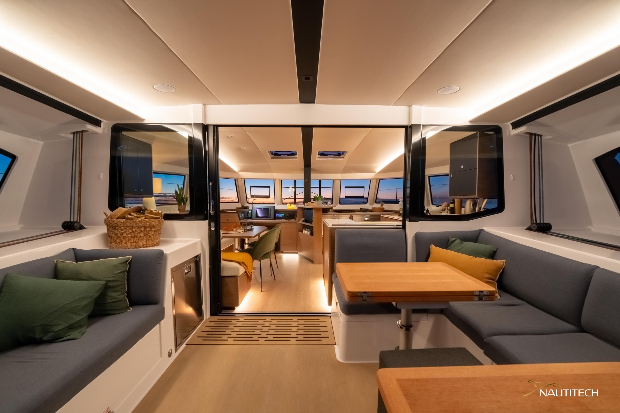 Luxurious interior of 2025 Nautitech 48 Open catamaran, featuring modern seating and dining area.