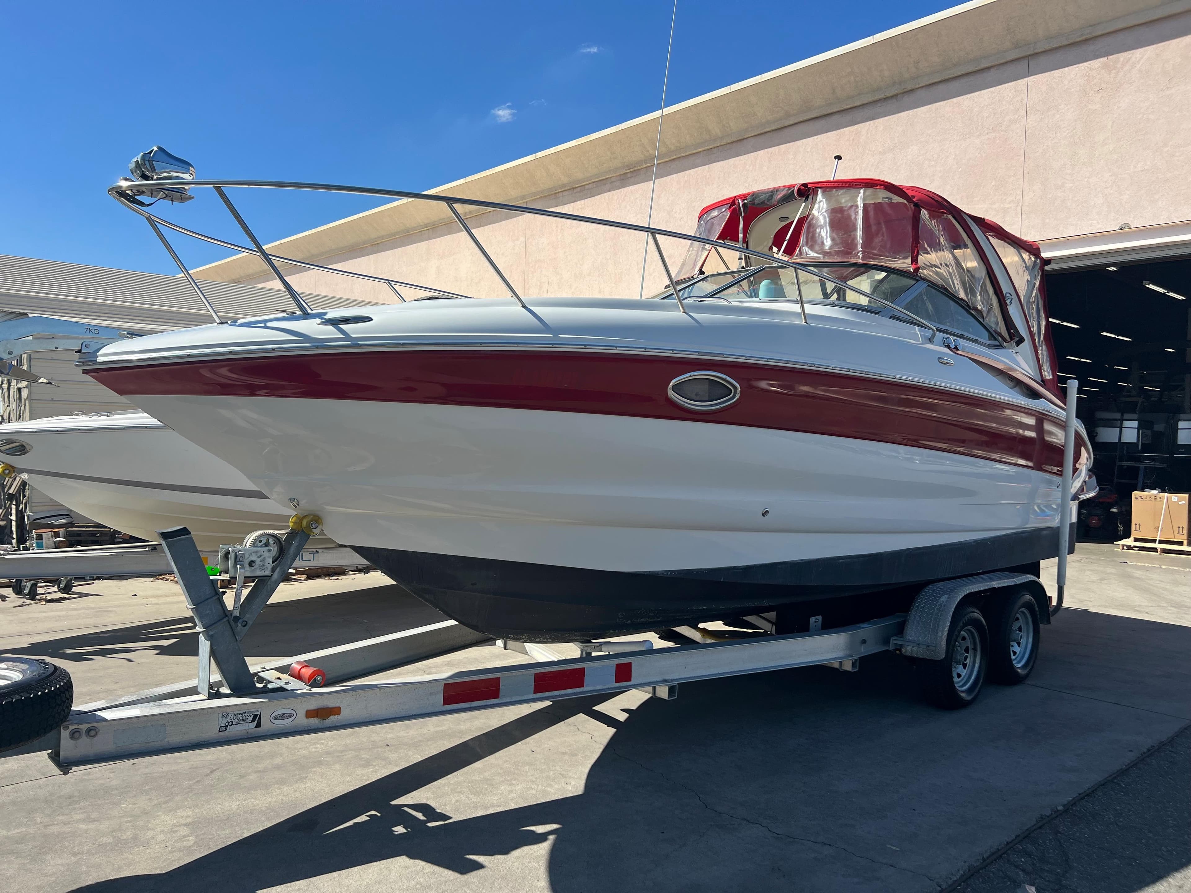 2007 Crownline 250 CR boat on a trailer with red and white exterior.