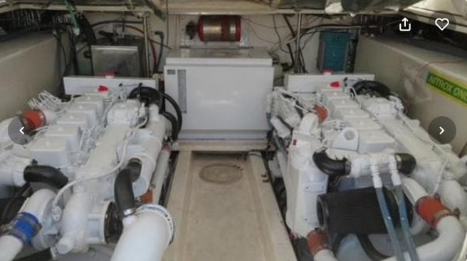 Engine room of a 2001 Topaz Express boat, featuring dual engines and mechanical components.